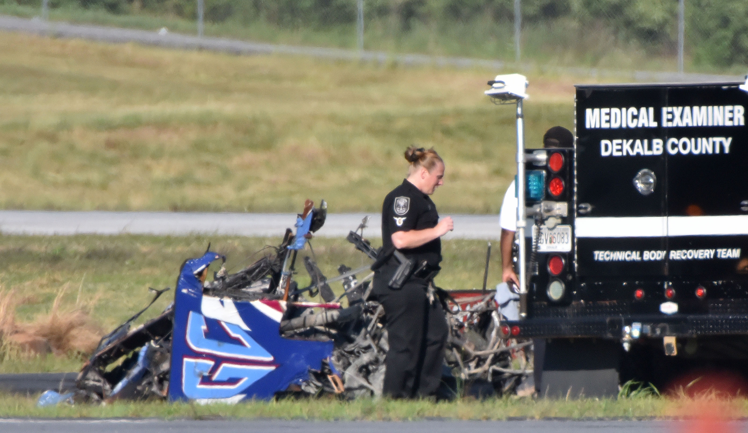 Authorities investigate the site of a small plane crash at DeKalb Peachtree Airport on Saturday, May 14, 2016, near the end of the Good Neighbor Day Air Show. (Hyosub Shin/Atlanta Journal-Constitution via AP) MARIETTA DAILY OUT; GWINNETT DAILY POST OUT; 