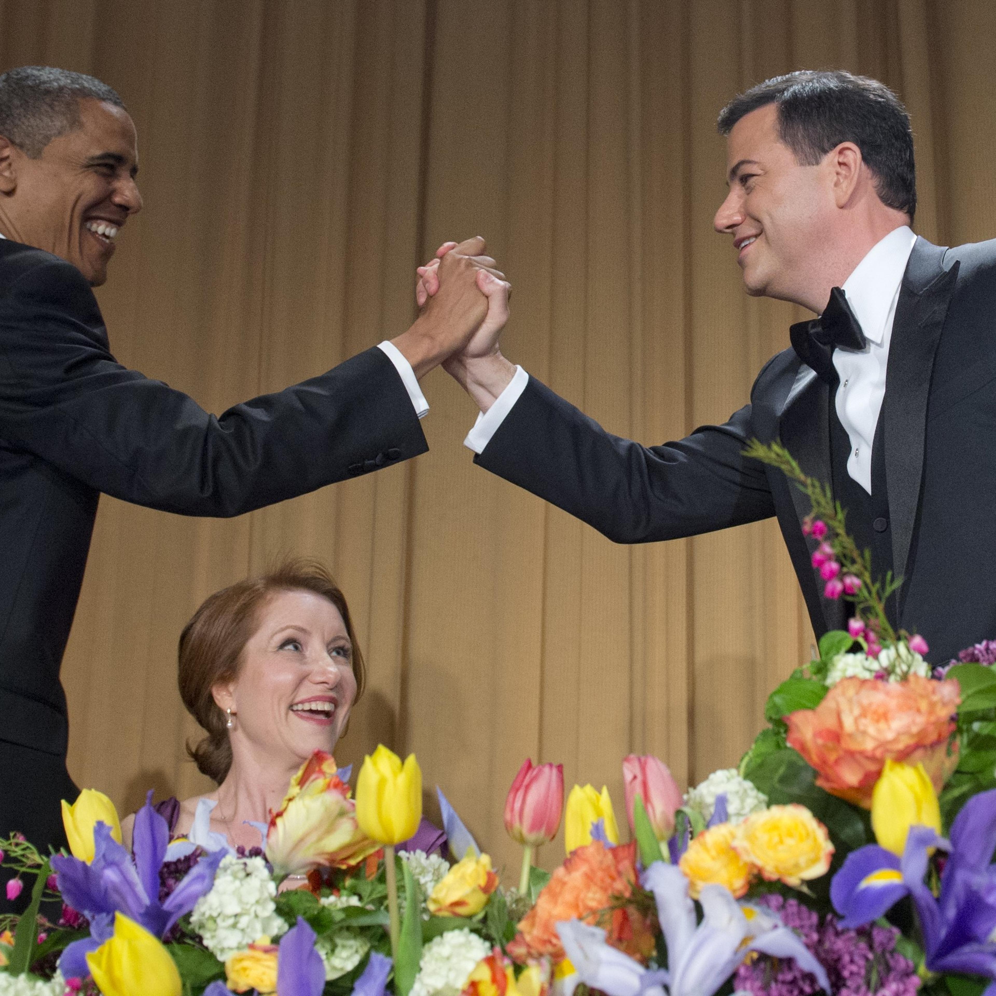 US President Barack Obama high-fives television host Jimmy Kimmel (R) during the White House Correspondents Association Dinner in Washington on April 28, 2012.