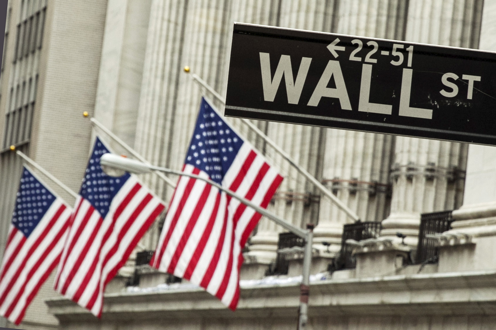 A sign hangs in front of U.S. flags outside of the New York Stock Exchange in New York