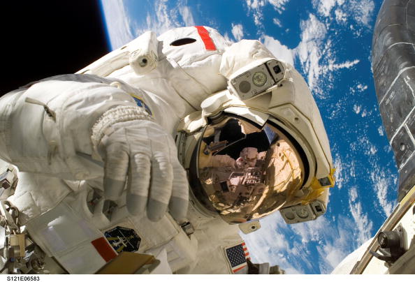 Space Shuttle Astronauts Work Aboard Space Station