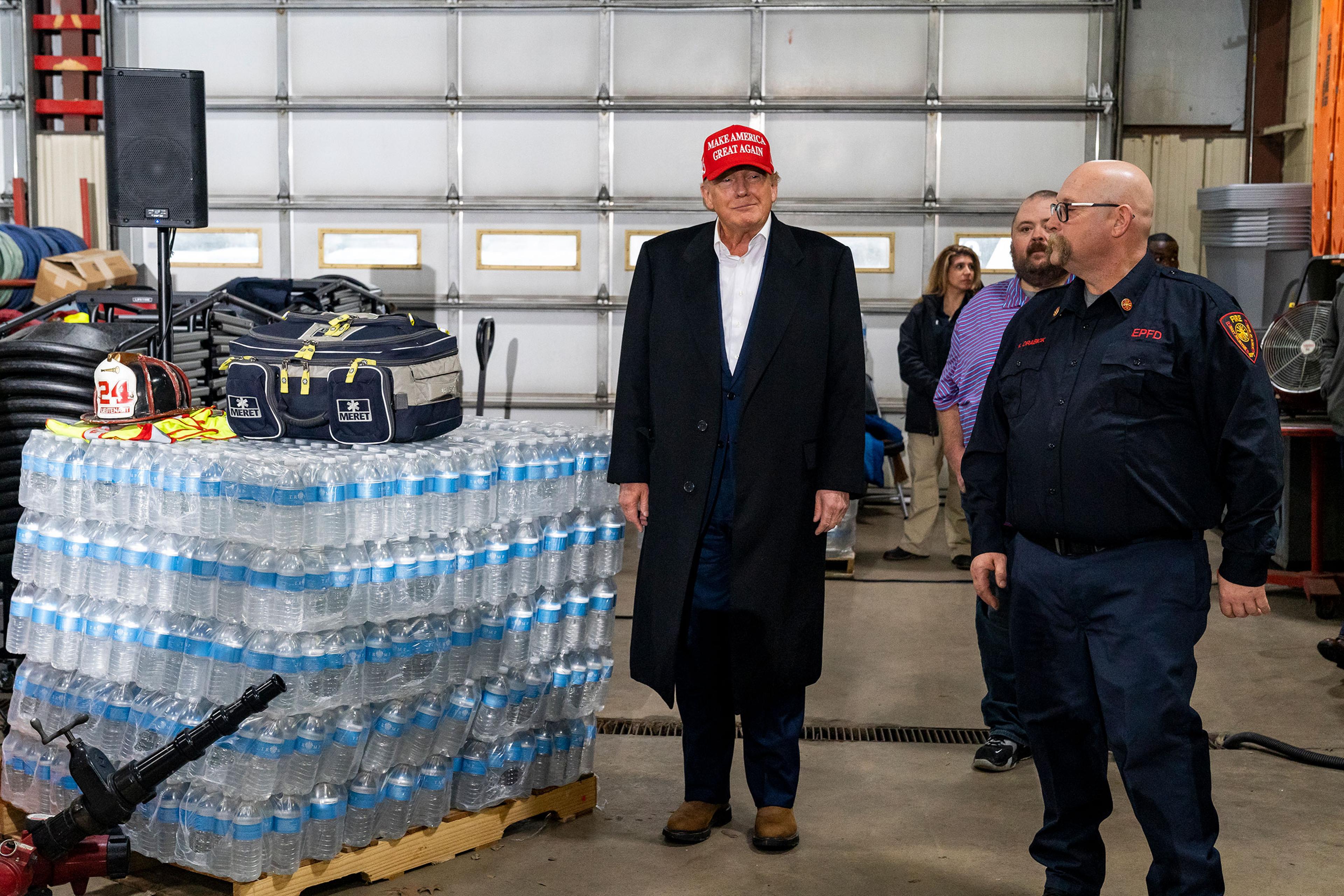 Former President Donald Trump stands next to a pallet of water before delivering remarks at the East Palestine Fire Department station in East Palestine, Ohio on Feb. 22. On Feb. 3 a Norfolk Southern Railways train carrying toxic chemicals derailed causi