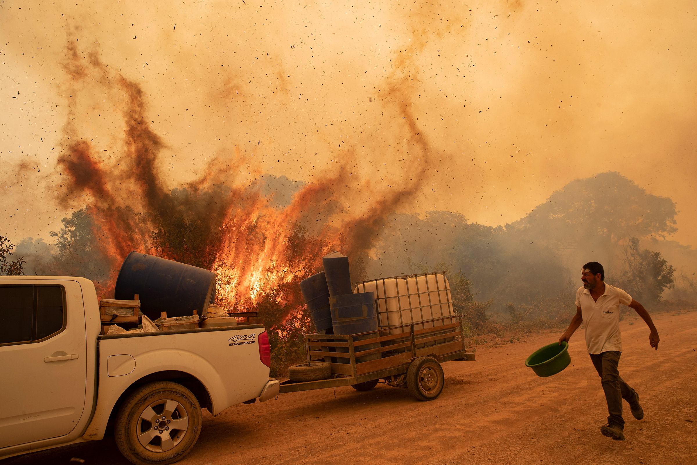 A volunteer works to douse a fire on Transpantaneira, the road that crosses the Pantanal, near Pocone in the Brazilian state of Mato Grosso on Sept. 11.