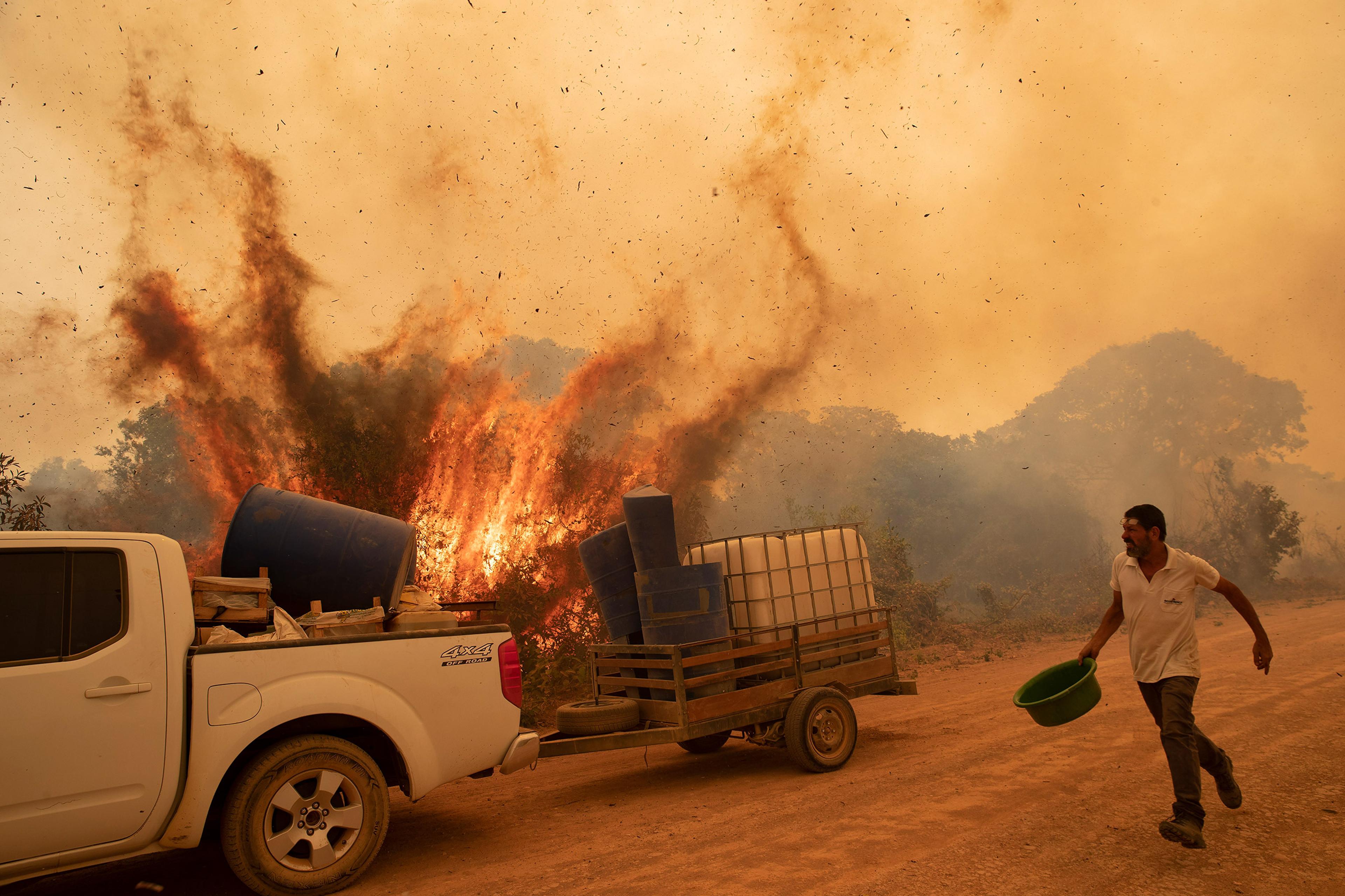 A volunteer works to douse a fire on Transpantaneira, the road that crosses the Pantanal, near Pocone in the Brazilian state of Mato Grosso on Sept. 11.