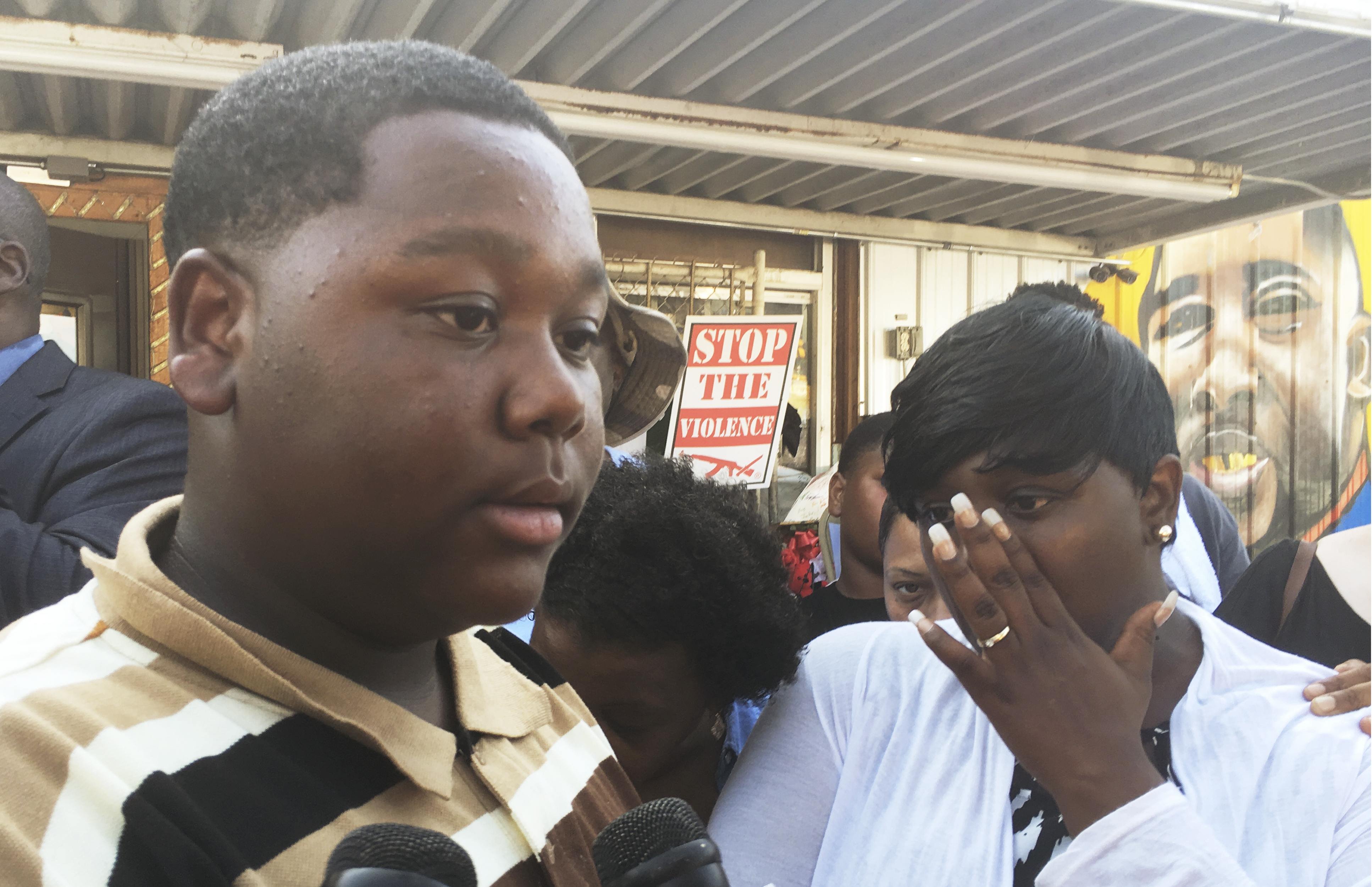 Cameron Sterling speaks as his mother Quinyetta McMillon looks on in front of a Louisiana convenience store where his father was killed by police in Baton Rouge