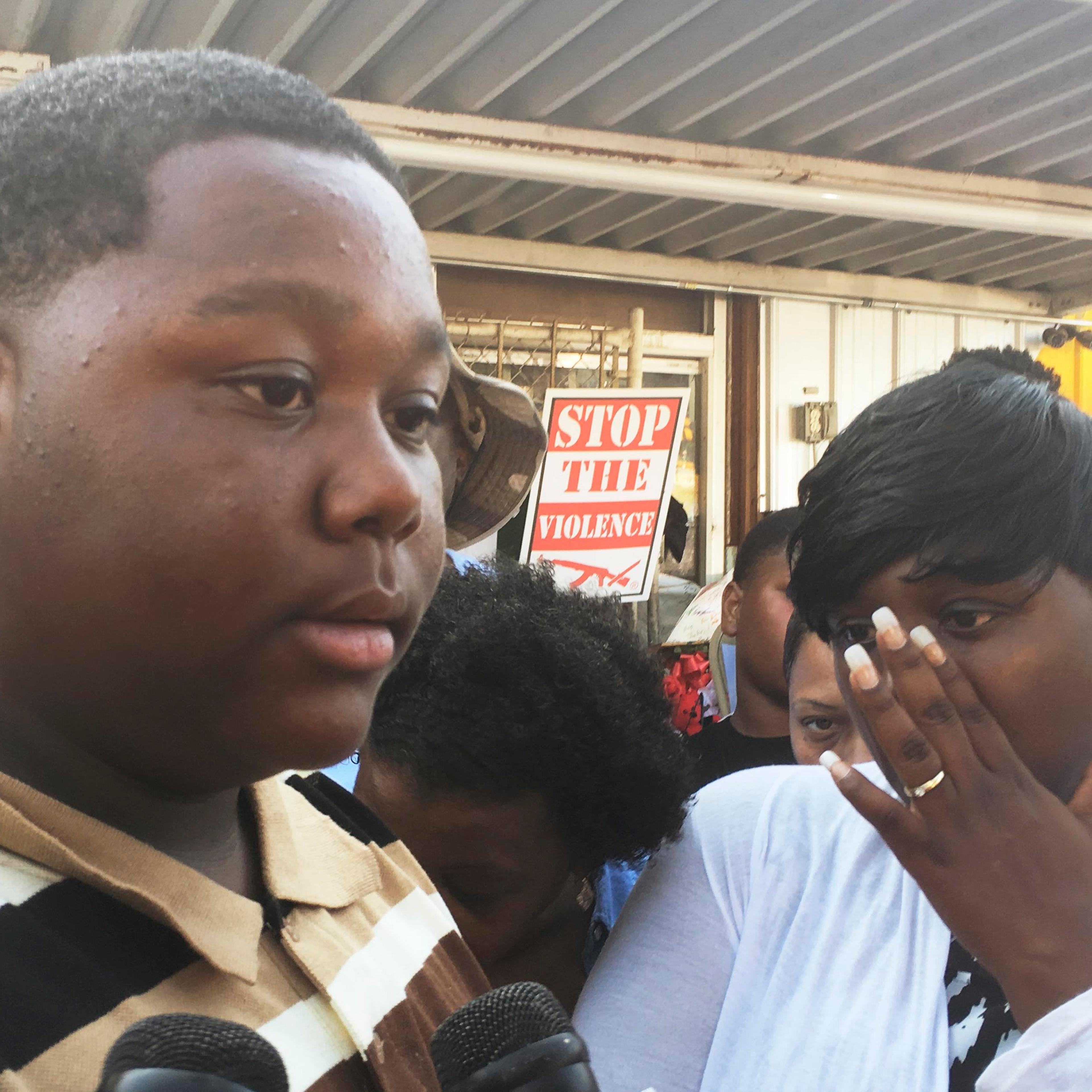 Cameron Sterling speaks as his mother Quinyetta McMillon looks on in front of a Louisiana convenience store where his father was killed by police in Baton Rouge