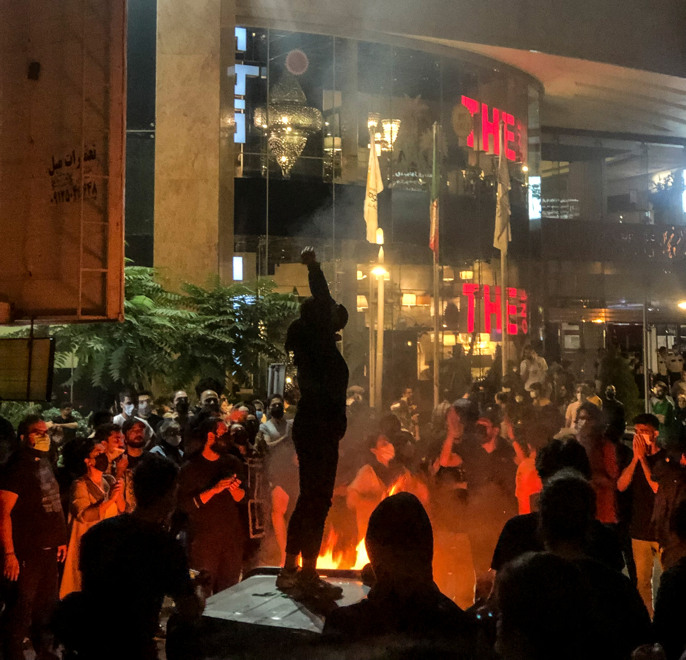 People gather during a protest for Mahsa Amini, who died after being arrested by morality police allegedly not complying with strict dress code in Tehran, Iran on Sept 22, 2022.