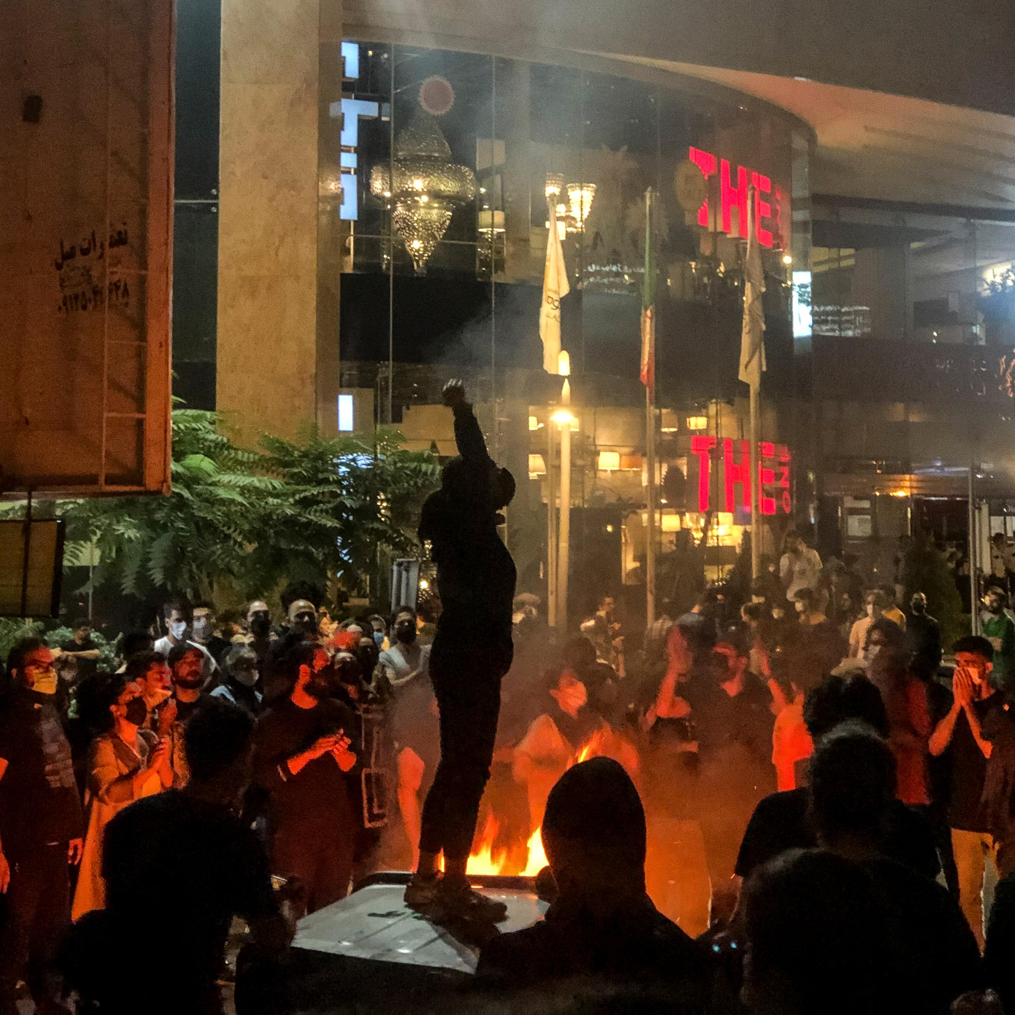 People gather during a protest for Mahsa Amini, who died after being arrested by morality police allegedly not complying with strict dress code in Tehran, Iran on Sept 22, 2022.