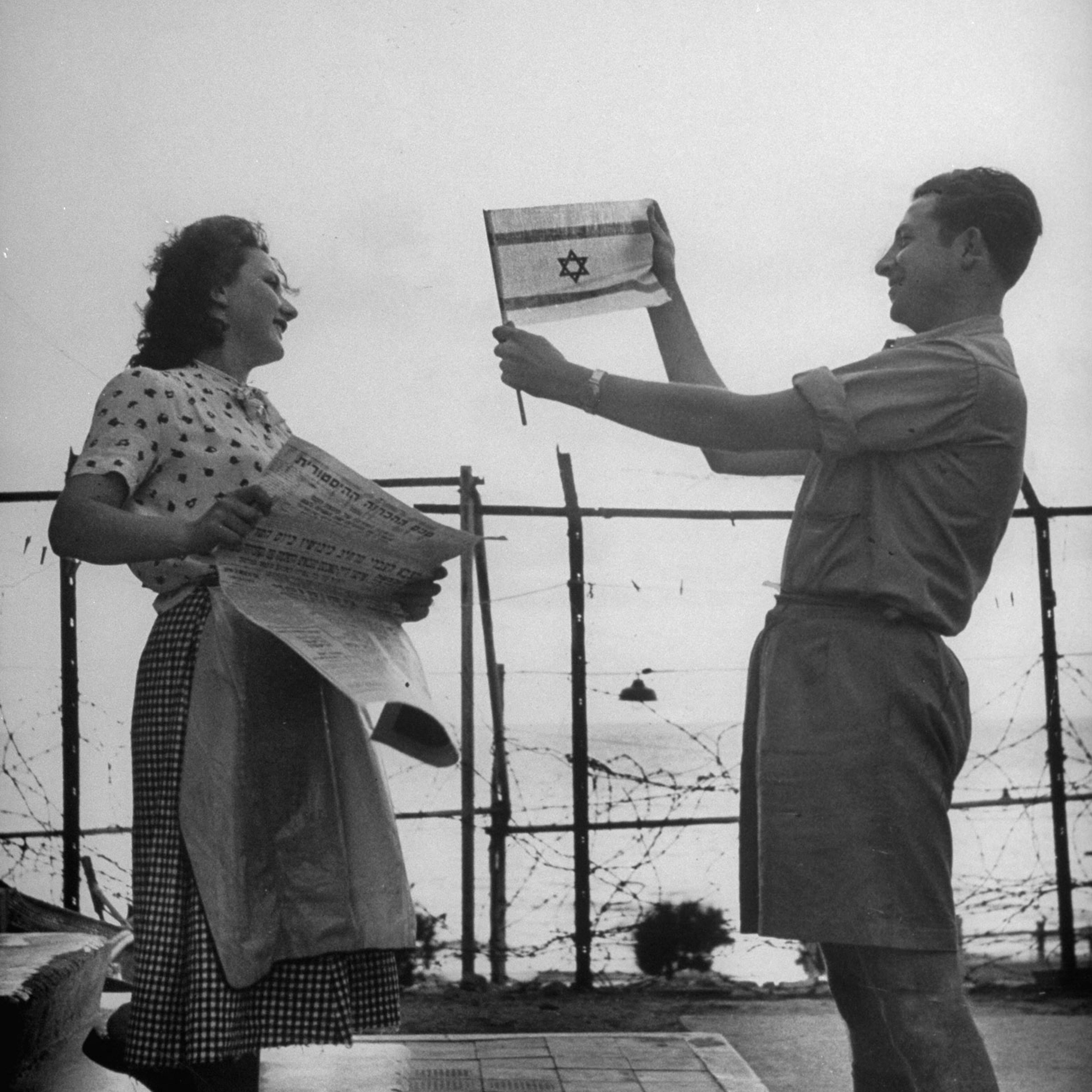 Happily displaying the Israeli flag shortly after the establishment of the state of Israel, exact location unknown, May 1948.