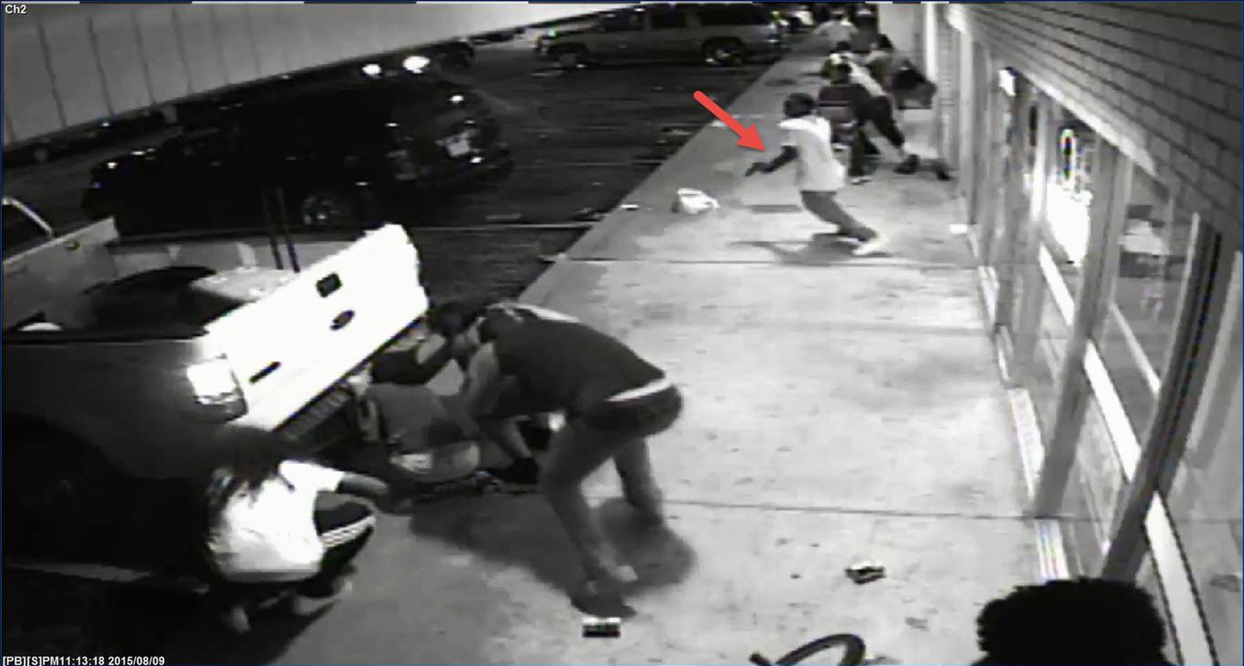 ST. LOUIS, MO - AUGUST 09: In this handout provided by the St. Louis County Police Department, video surveillance taken from Solo Insurance Services, appears to show Tyrone Harris Jr. grab a handgun out of his waistband once shots are fired during the pr