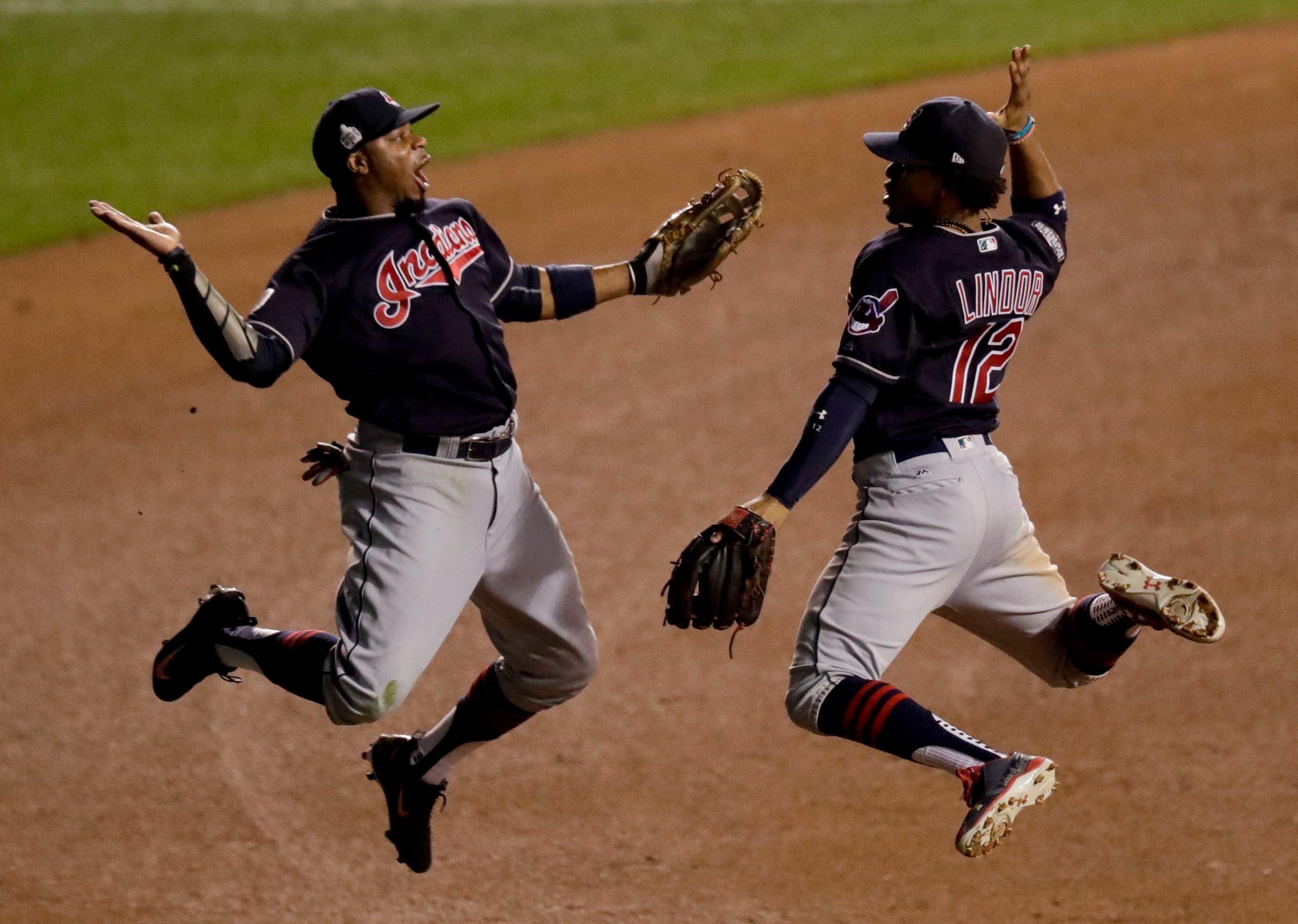 Cleveland Indians left fielder Rajai Davis, left, and shortstop Francisco Lindor celebrate their win after Game 4 of the Major League Baseball World Series against the Chicago Cubs Saturday, Oct. 29, 2016, in Chicago. The Indians won 7-2 to take a 3-1 le