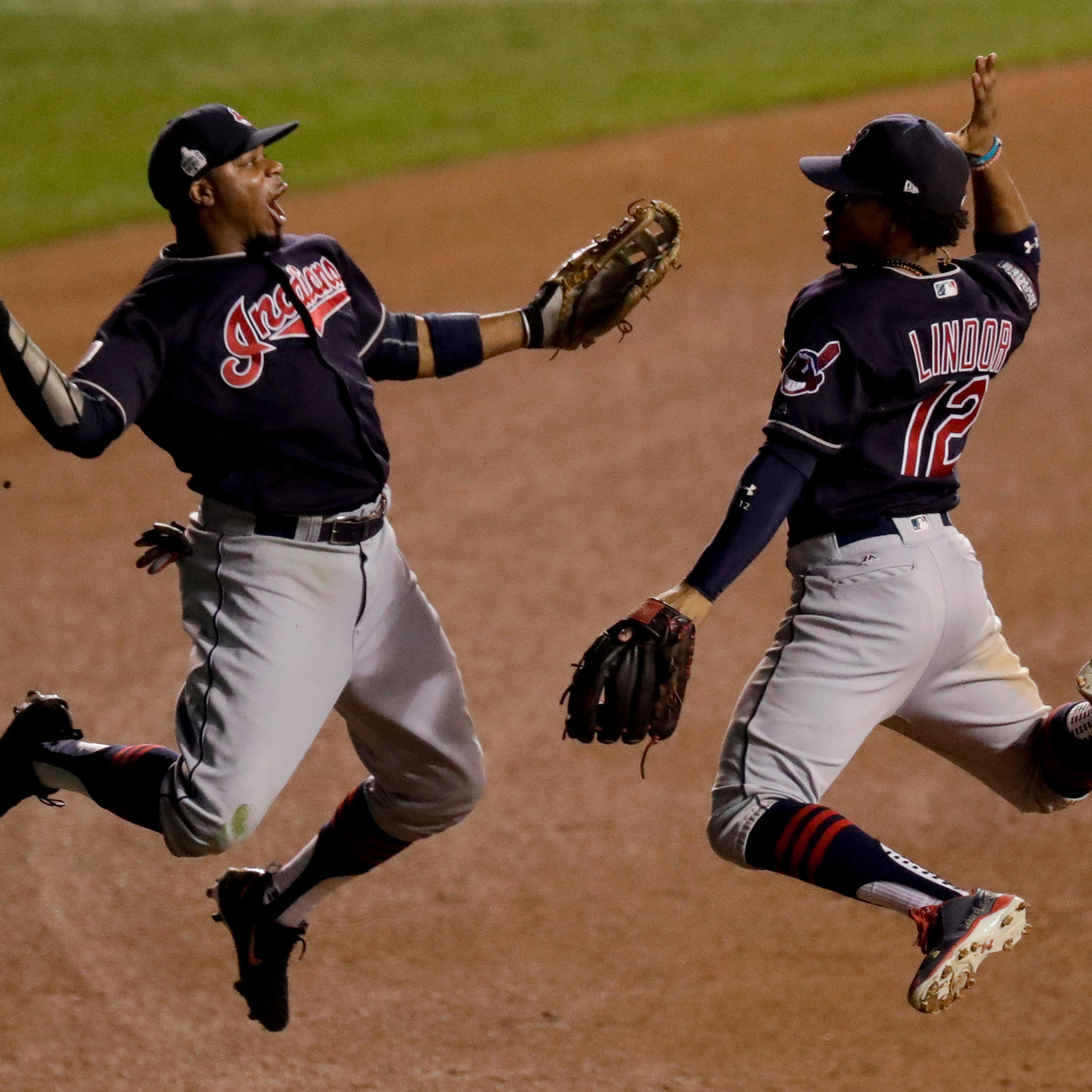 Cleveland Indians left fielder Rajai Davis, left, and shortstop Francisco Lindor celebrate their win after Game 4 of the Major League Baseball World Series against the Chicago Cubs Saturday, Oct. 29, 2016, in Chicago. The Indians won 7-2 to take a 3-1 le