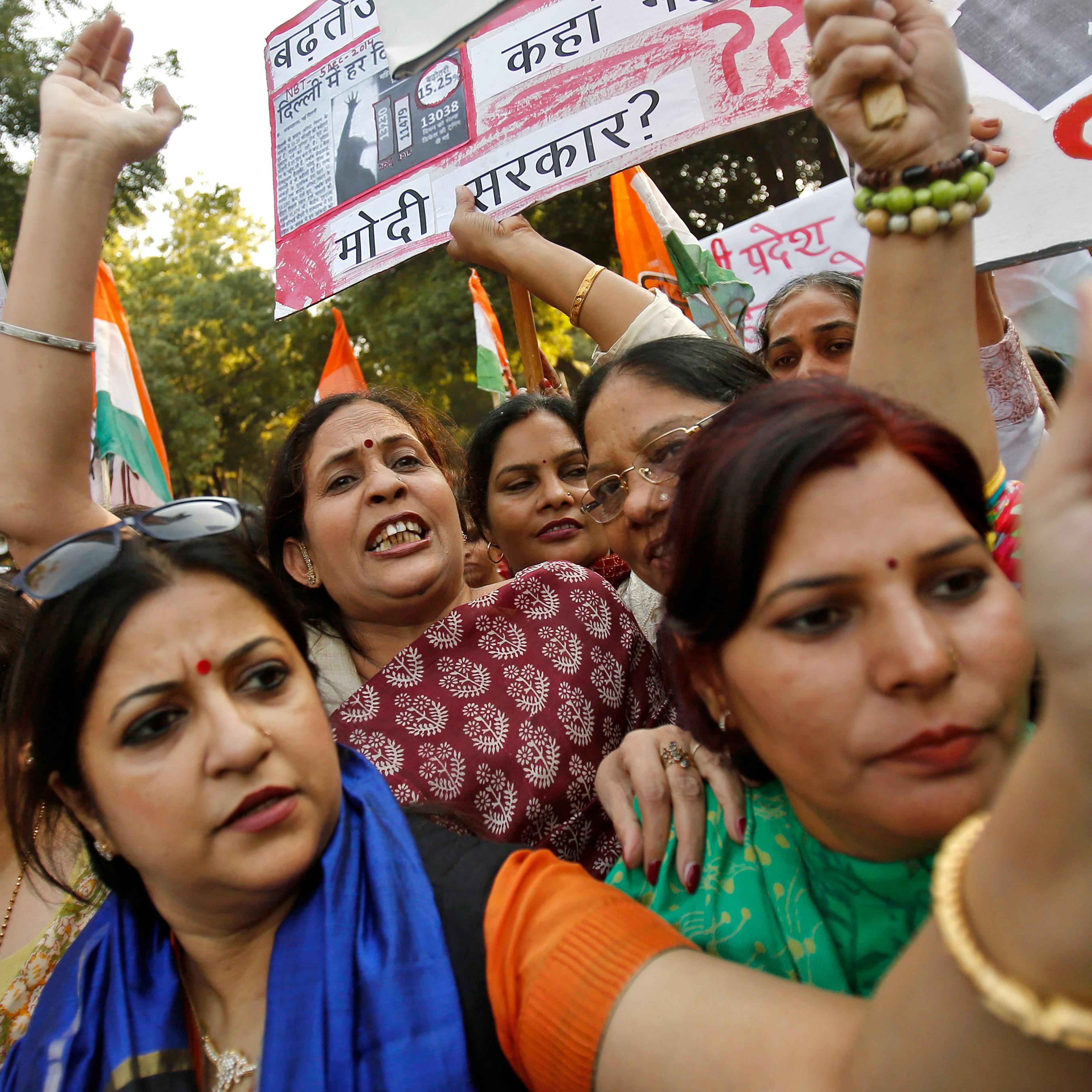 Members of All India Mahila Congress, women's wing of Congress party, shout slogans and carry placards during a protest against the rape of a female passenger, in New Delhi