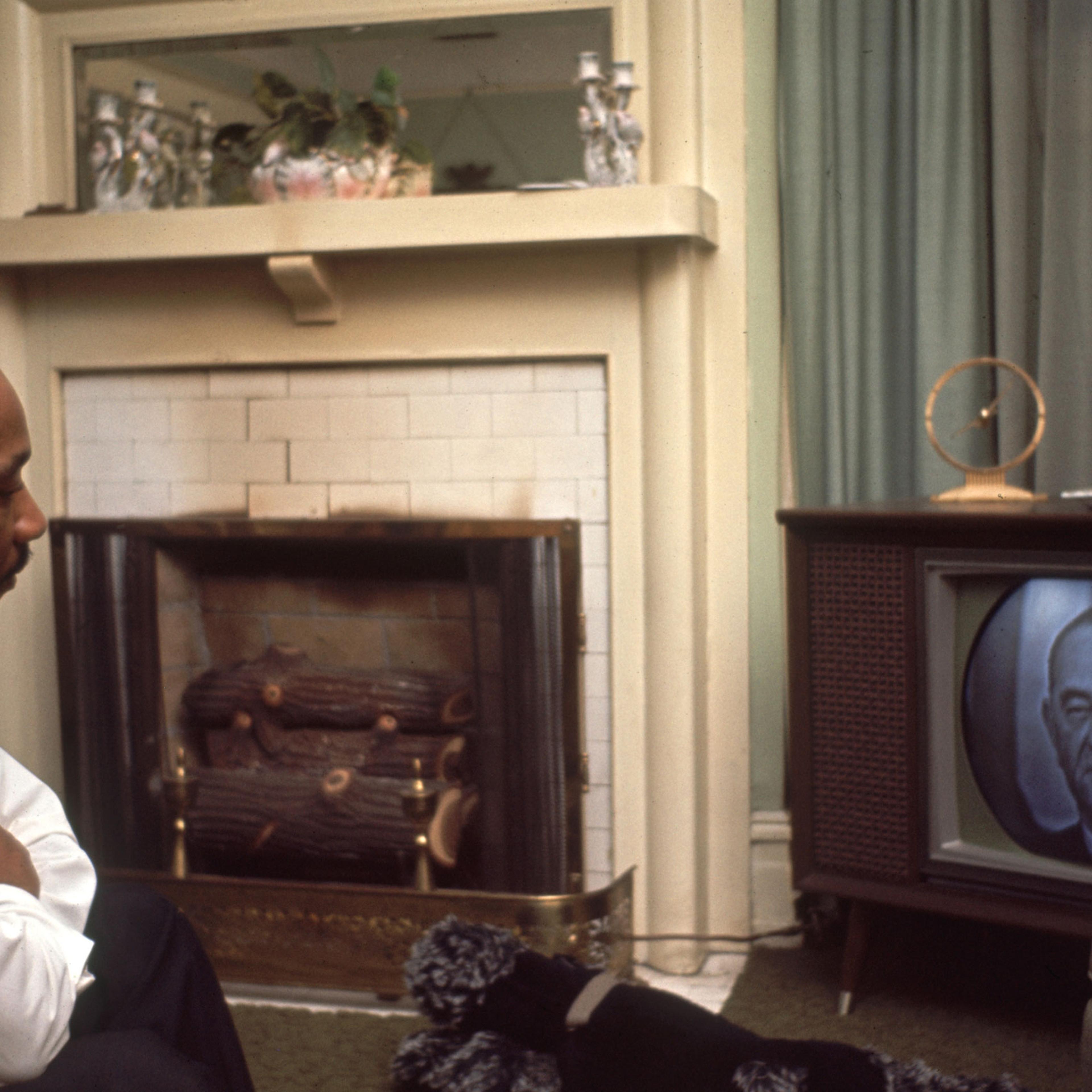 American religious and Civil Rights leader Martin Luther King Jr. watches US President Lyndon Johnson on television, Selma, Alabama, March 1965.