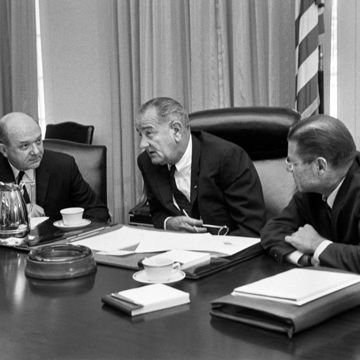 Secretary of Defense Robert McNamara (right), President Lyndon Johnson and Secretary of State Dean Rusk, seated at a table after McNamara's return from South Vietnam, in Washington, on July 21, 1965.