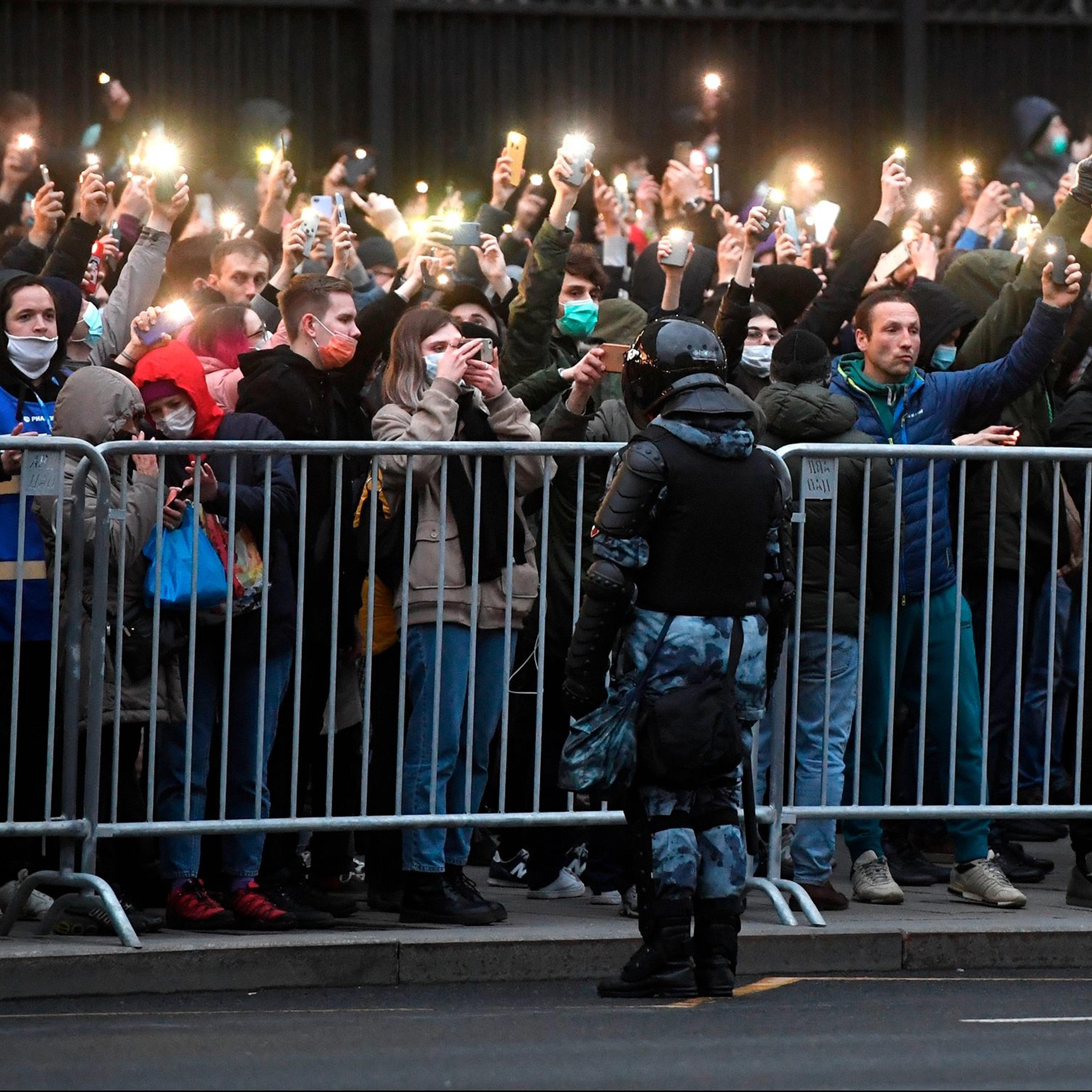 Protesters hold phones with flashlights turned on during a rally in support of jailed Russian opposition activist Alexei Navalny in Moscow on April 21.
