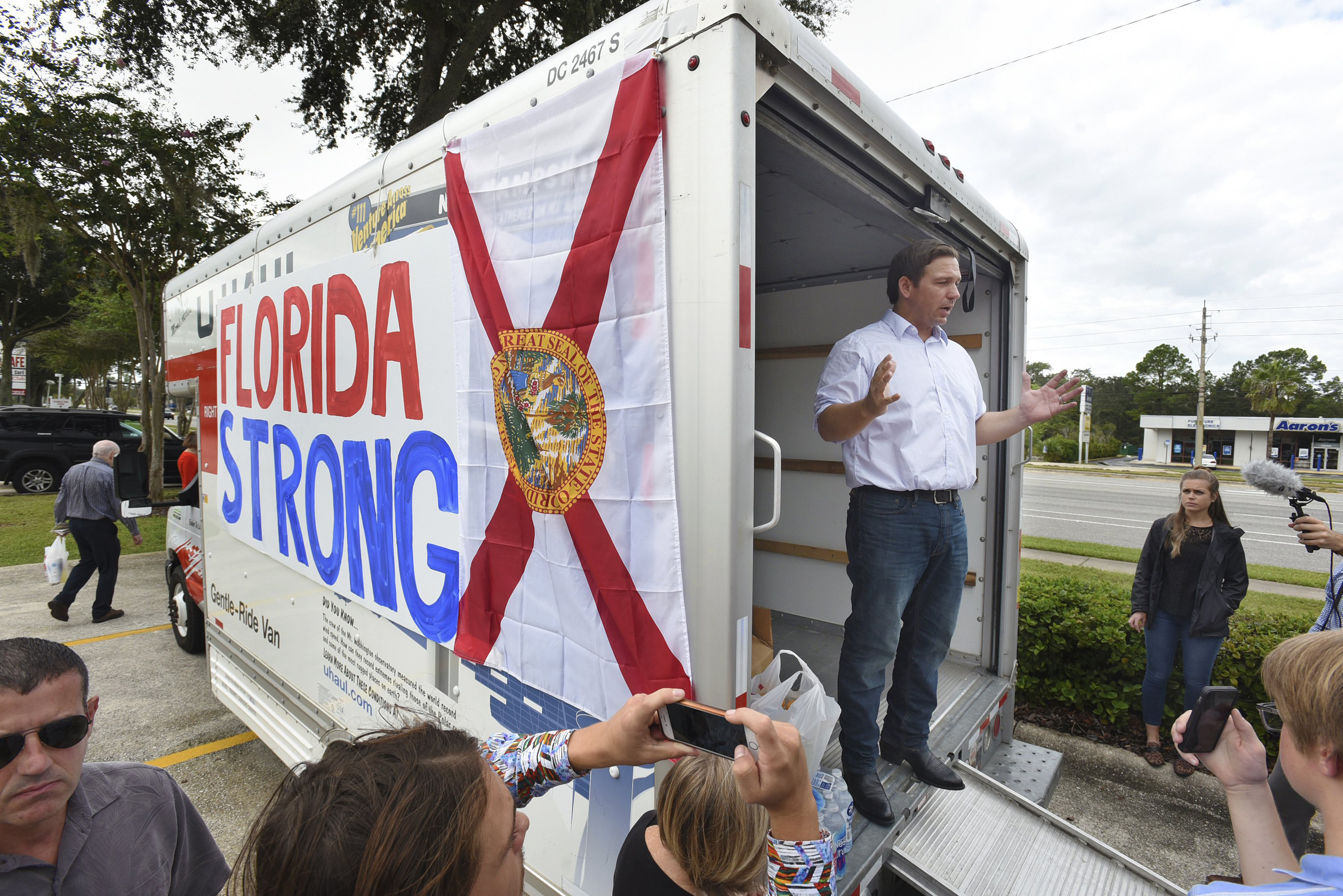 Florida gubernatorial candidate Ron DeSantis combined a campaign stop for supporters with a collection drive for water and canned goods for those in need at a shopping center in Jacksonville, Fla. on Oct. 10, 2018.