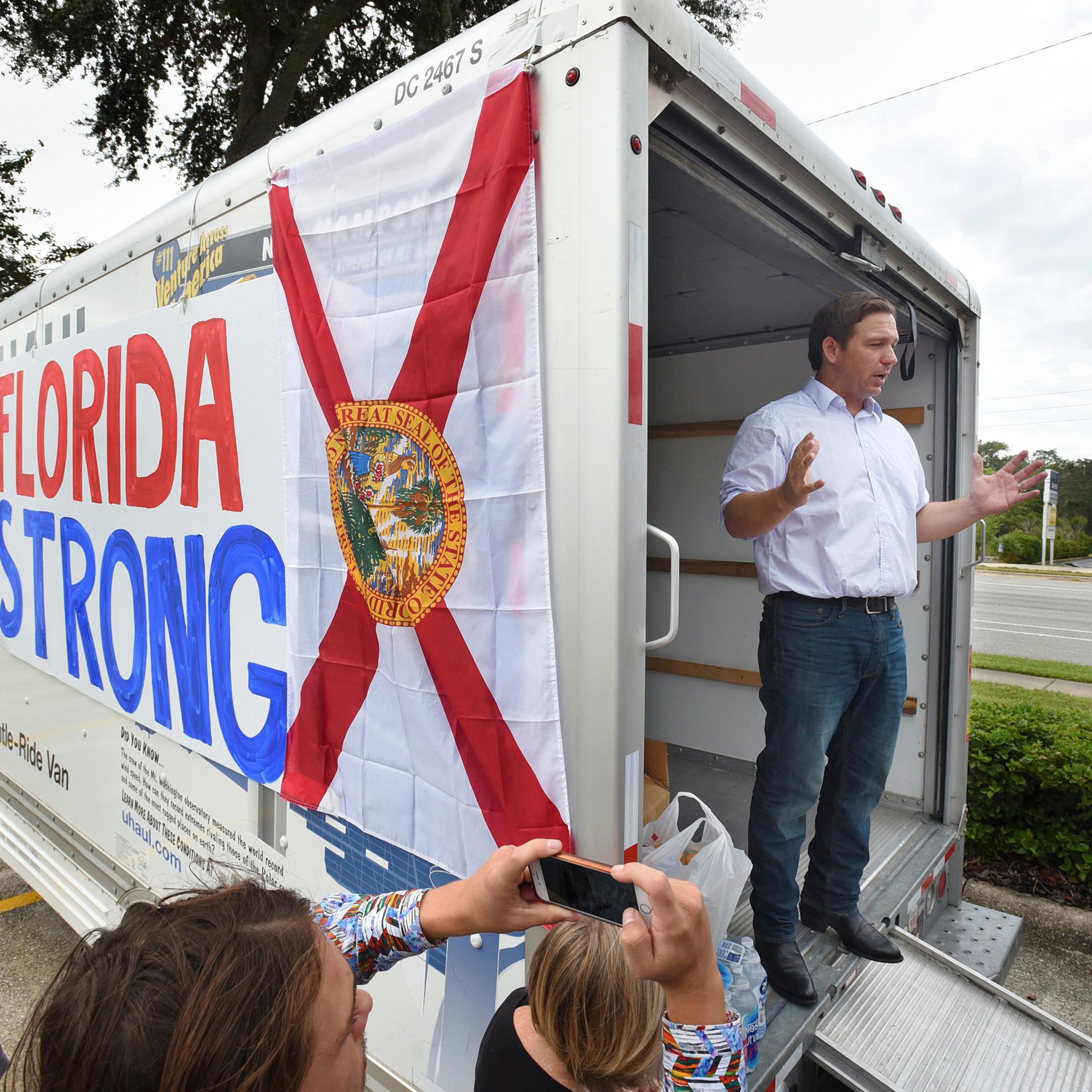 Florida gubernatorial candidate Ron DeSantis combined a campaign stop for supporters with a collection drive for water and canned goods for those in need at a shopping center in Jacksonville, Fla. on Oct. 10, 2018.