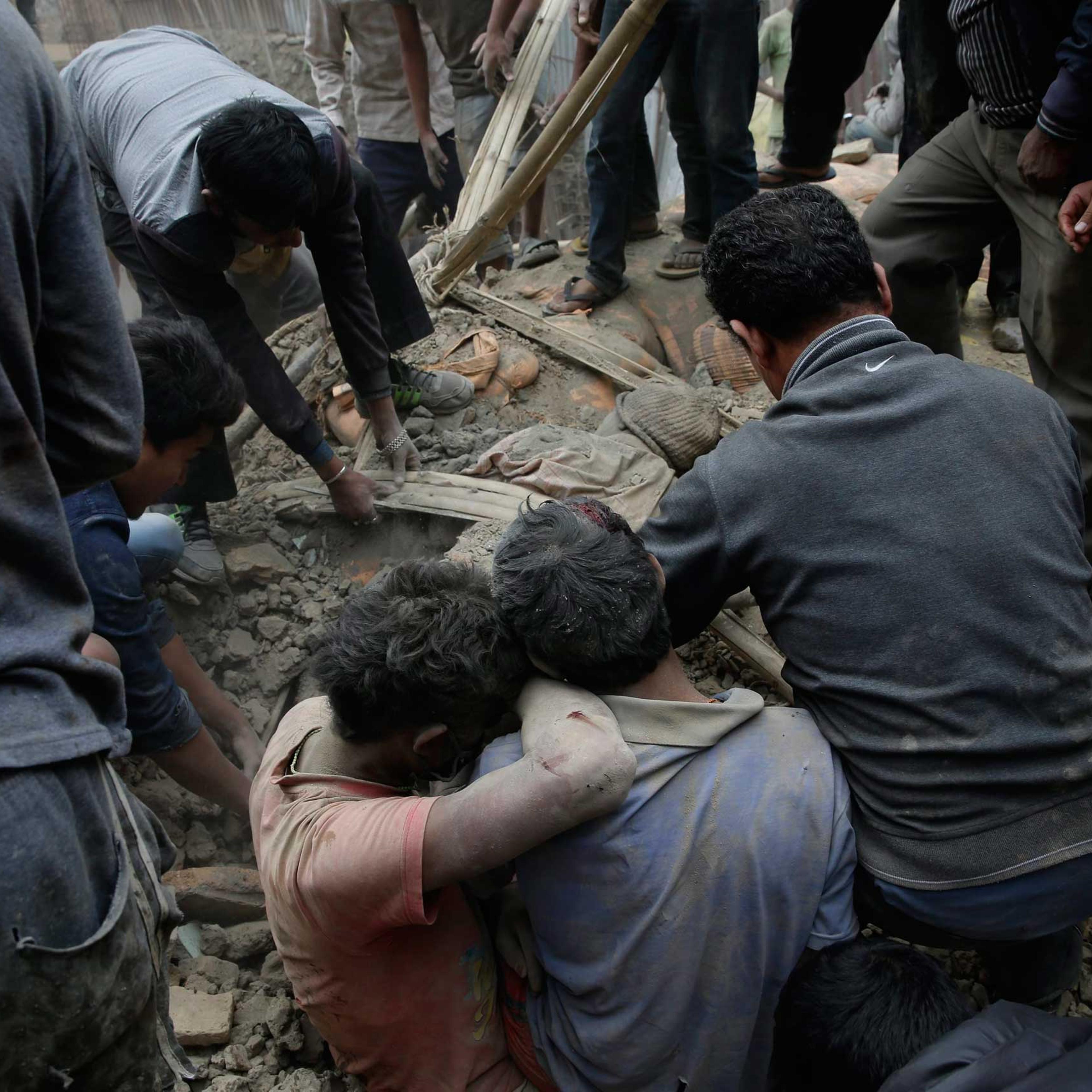 People dig through rubble for victims in Kathmandu.