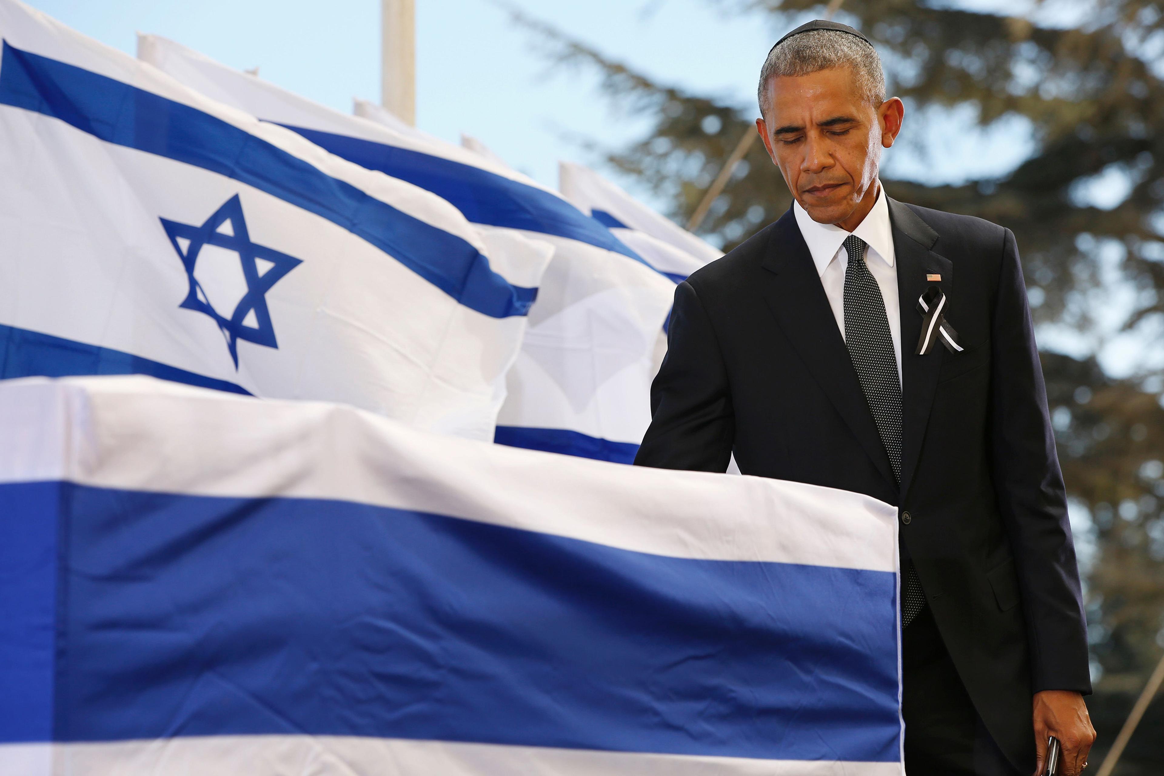 Barack Obama touches the coffin of former Israeli president and prime minister Shimon Peres after speaking during his funeral at Jerusalem's Mount Herzl national cemetery on Sept. 30, 2016.