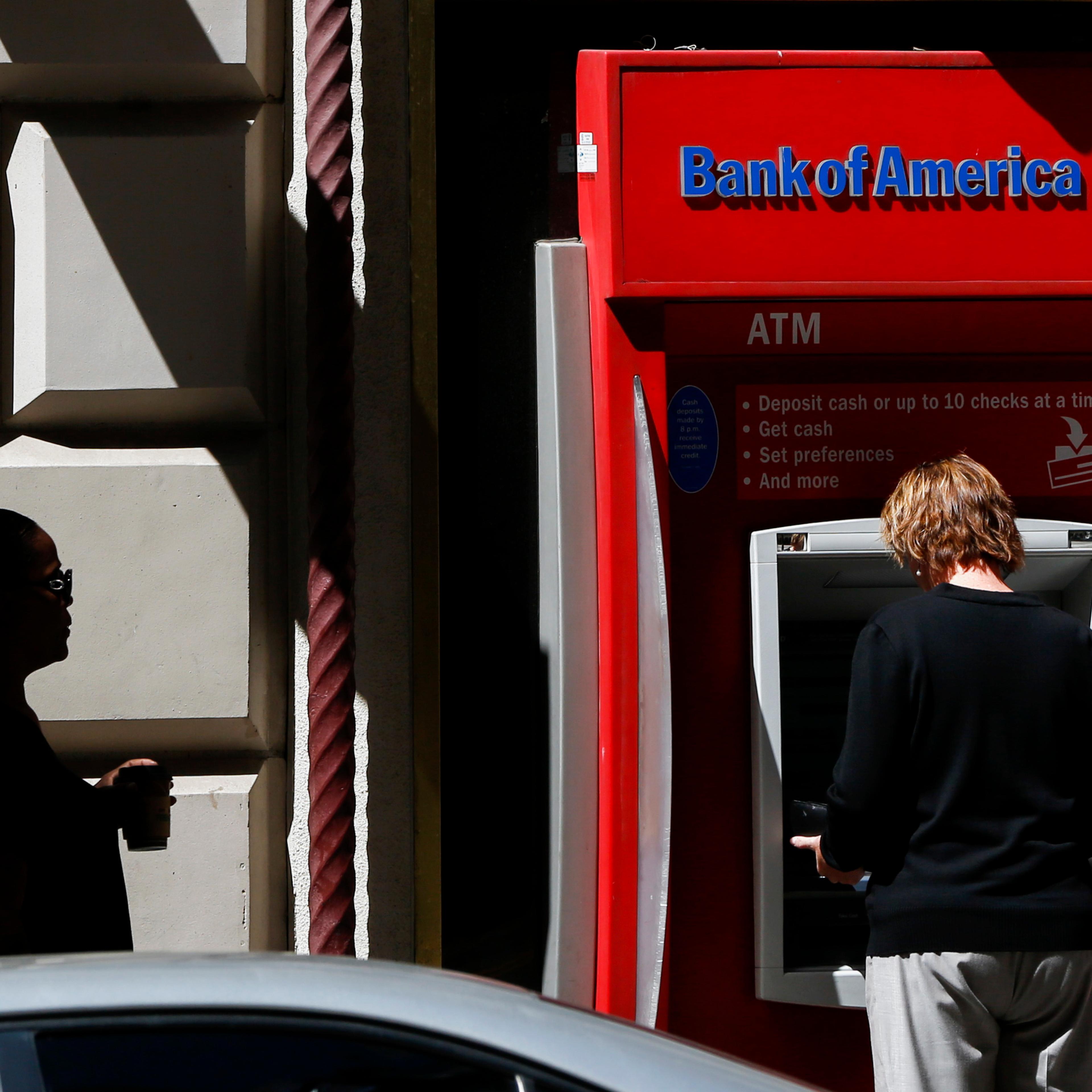 A woman uses a a Bank of America Corp. ATM outside of a branch in Los Angeles, California, U.S., on Monday, July 13, 2015. Photographer: Patrick T. Fallon/Bloomberg
