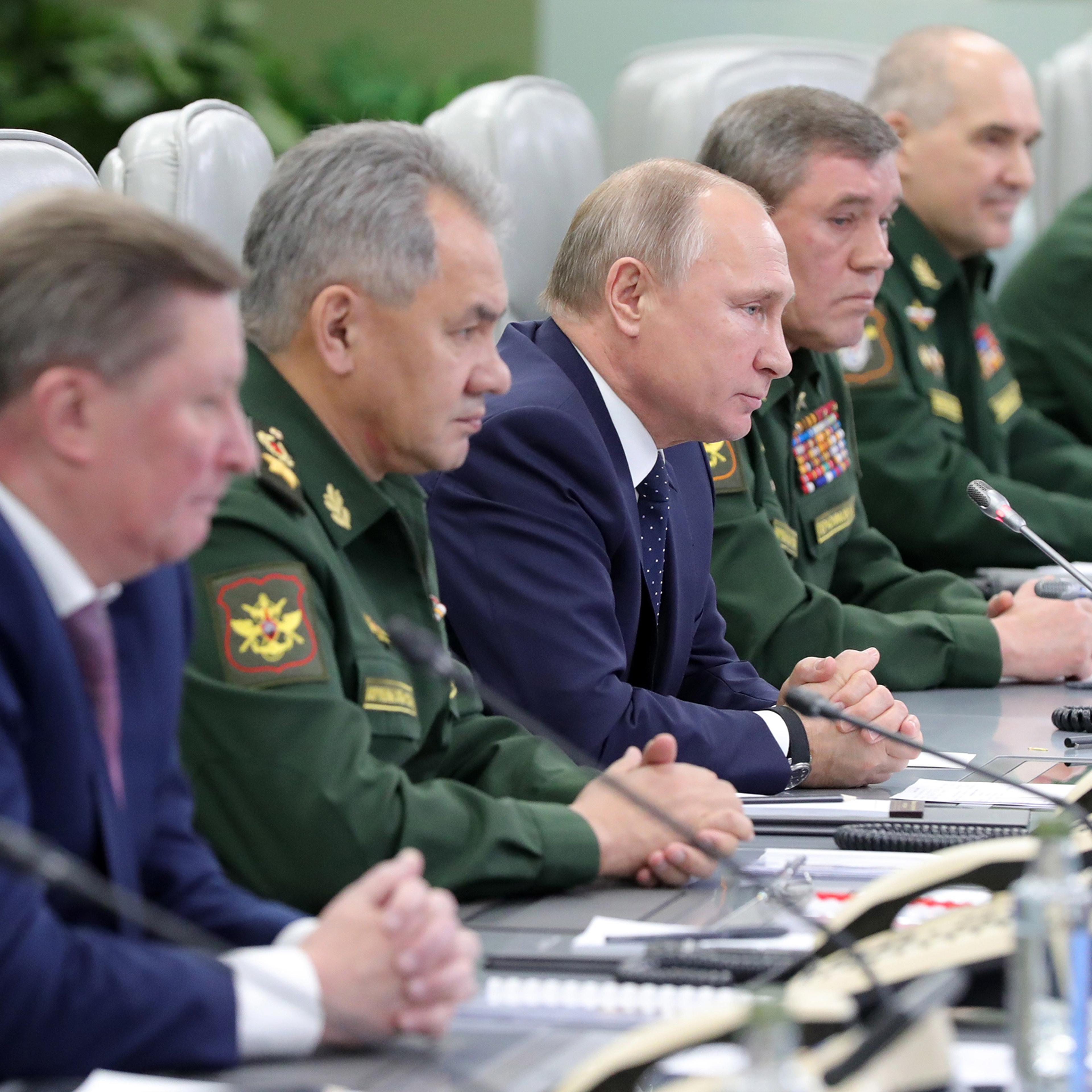 Vladimir Putin, center, watches the launch of a new Russian hypersonic missile system on Dec. 26