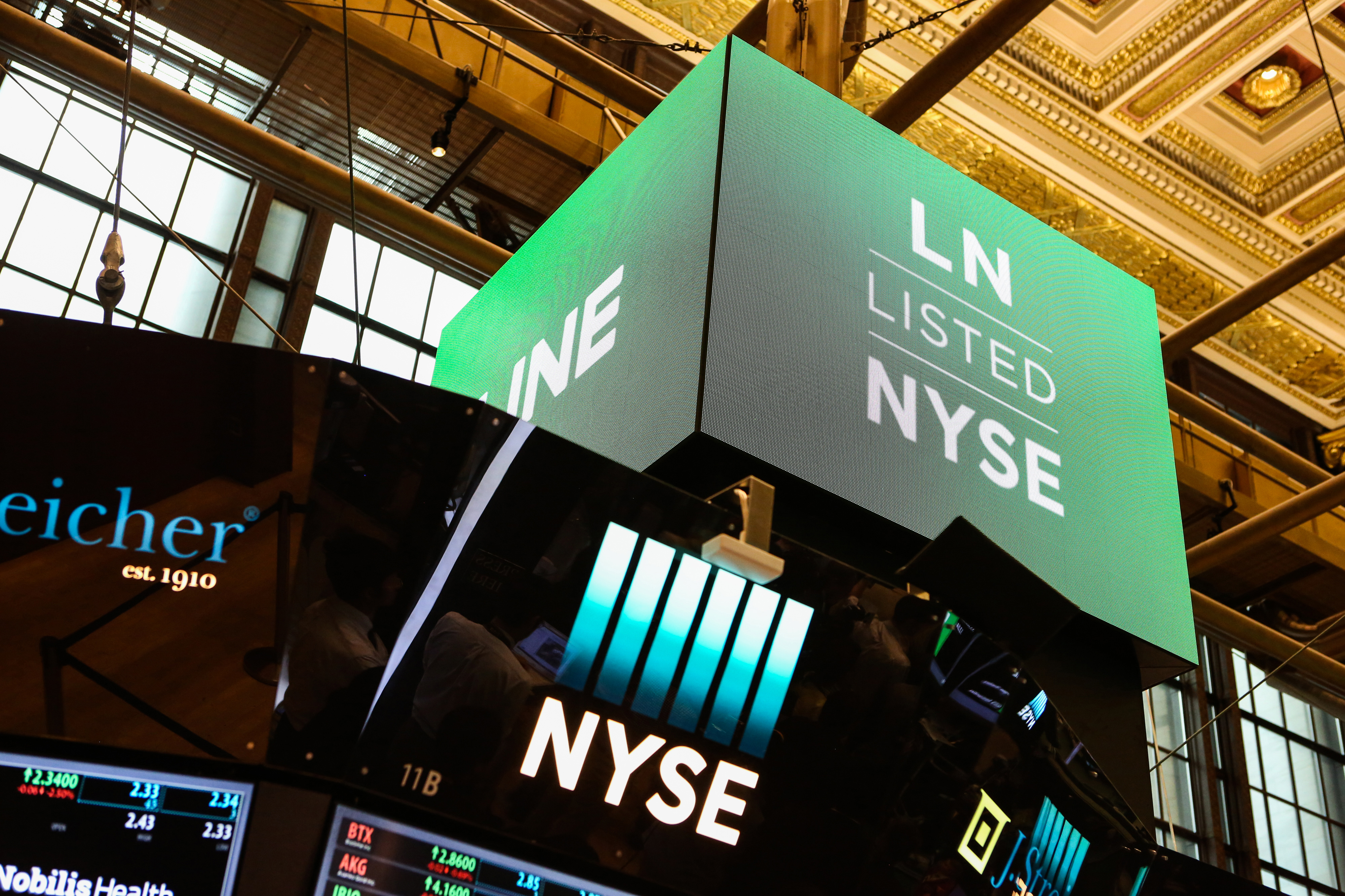 A monitor displays Line Corp. signage on the floor of the New York Stock Exchange (NYSE) in New York, U.S., on Thursday, July 14, 2016.