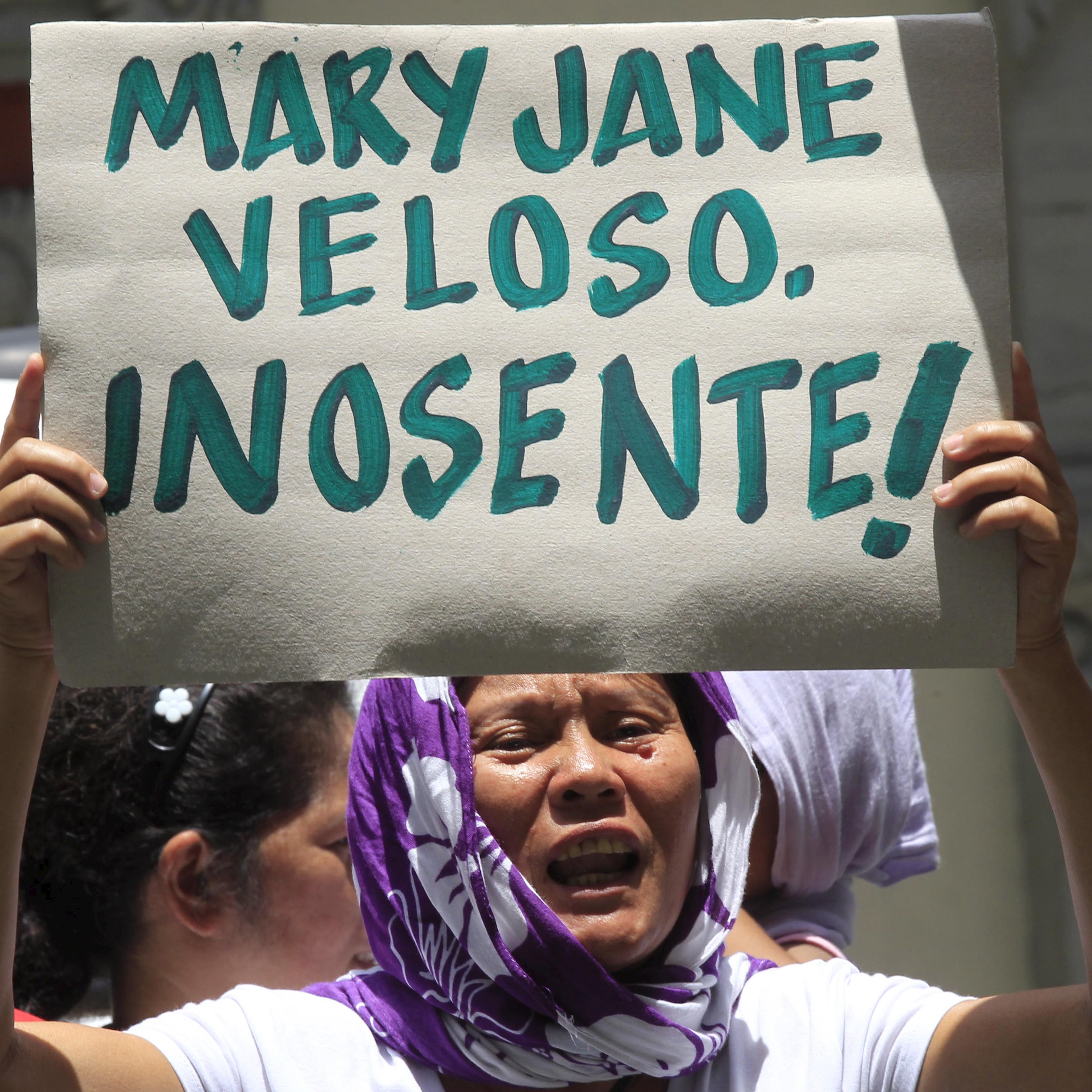 A protester holds a placard urging the Philippine and Indonesian government to save Mary Jane Veloso, a Filipina facing execution in Indonesia, during a protest in front of the Indonesian embassy in Makati city