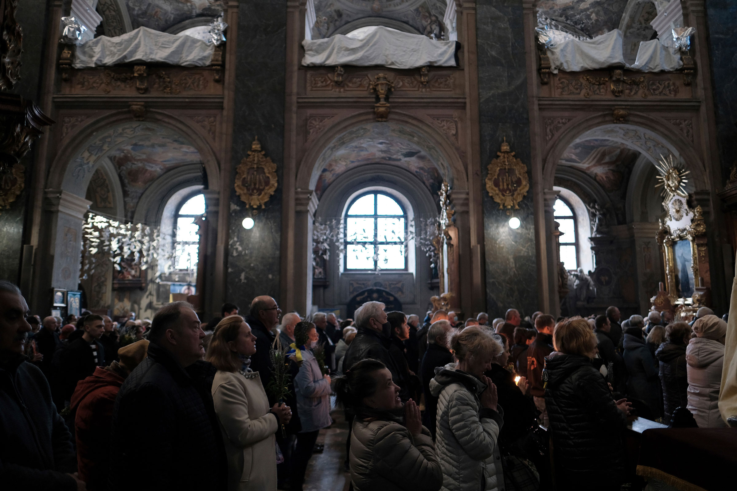 Local citizens attend a worship on Sunday before Easter at the Orthodox Church of Ukraine in Lviv