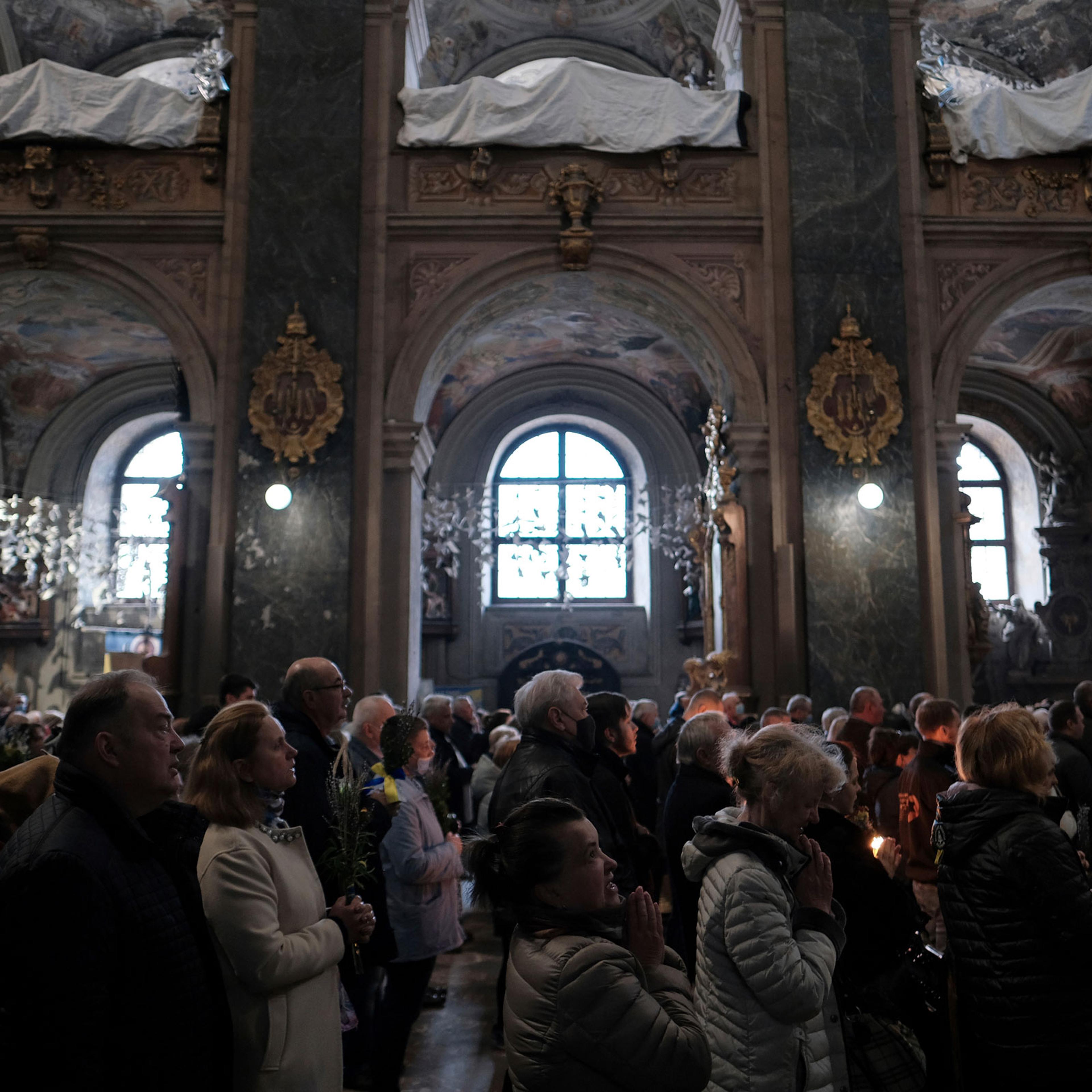 Local citizens attend a worship on Sunday before Easter at the Orthodox Church of Ukraine in Lviv