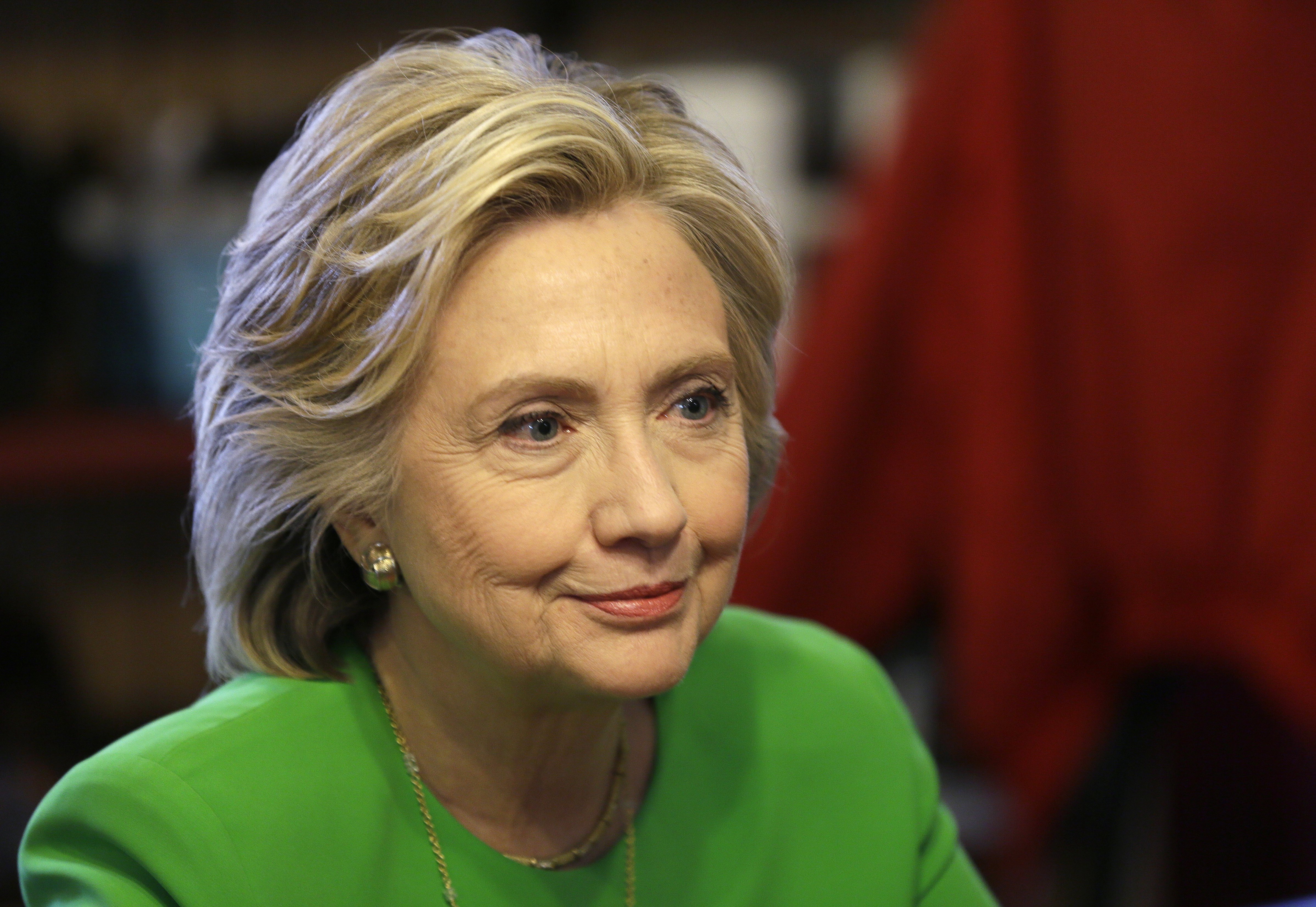 Democratic presidential candidate Hillary Rodham Clinton meets with local residents at the Jones St. Java House in LeClaire, Iowa on April 14, 2015.