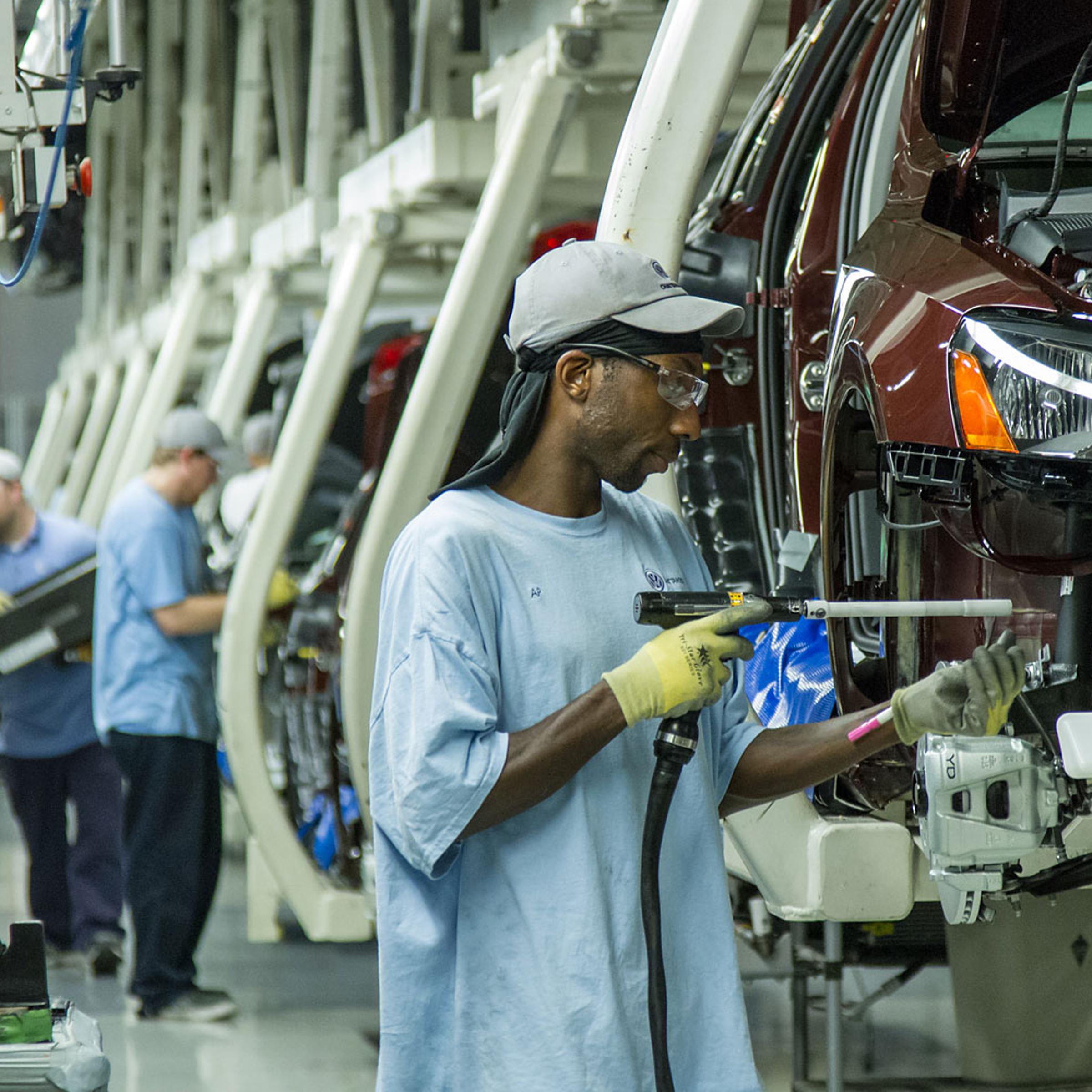 In this June 12, 2013, photo, workers assemble Volkswagen Passat sedans at the German automaker's plant in Chattanooga, Tenn.
