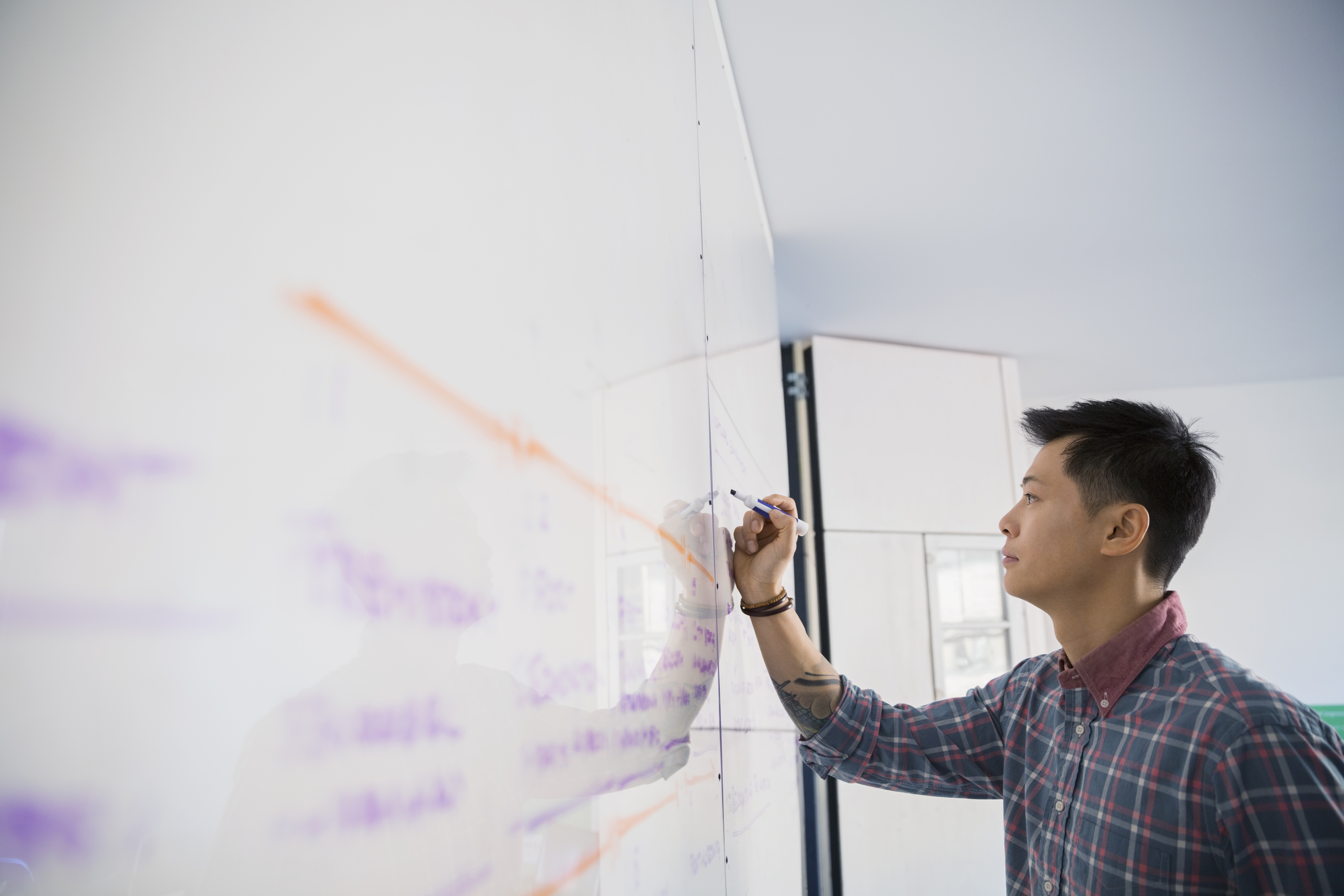 man-writing-whiteboard