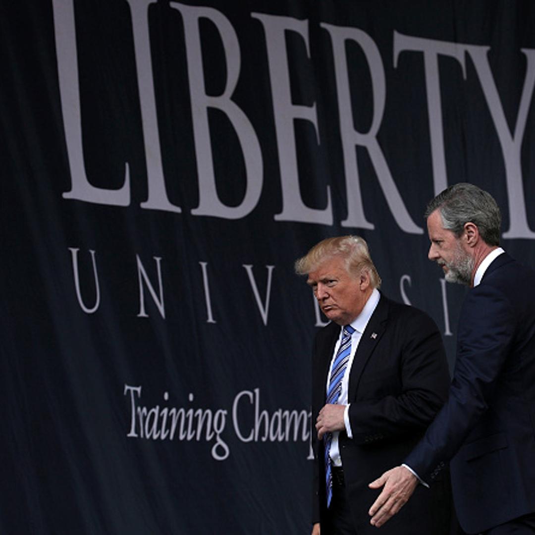 Accompanied by President Jerry Falwell (R), U.S. President Donald Trump (L) leaves after he delivered keynote address during the commencement at Liberty University May 13, 2017 in Lynchburg, Virginia.
