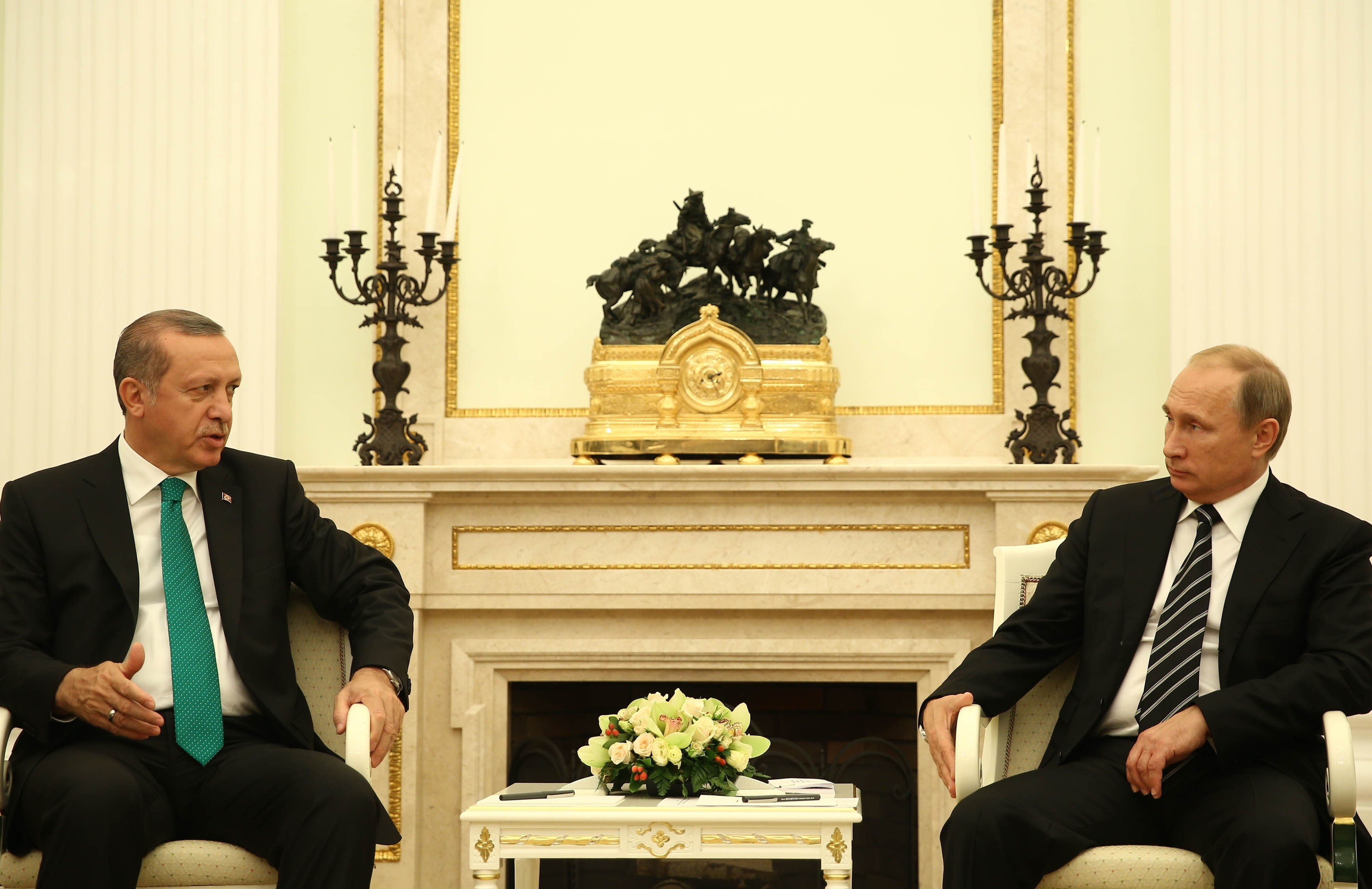 Turkey's President Recep Tayyip Erdogan (L) meets Russian President Vladimir Putin (R) after attending the opening ceremony of the Moscow Central Mosque in Moscow on Sept. 23, 2015.