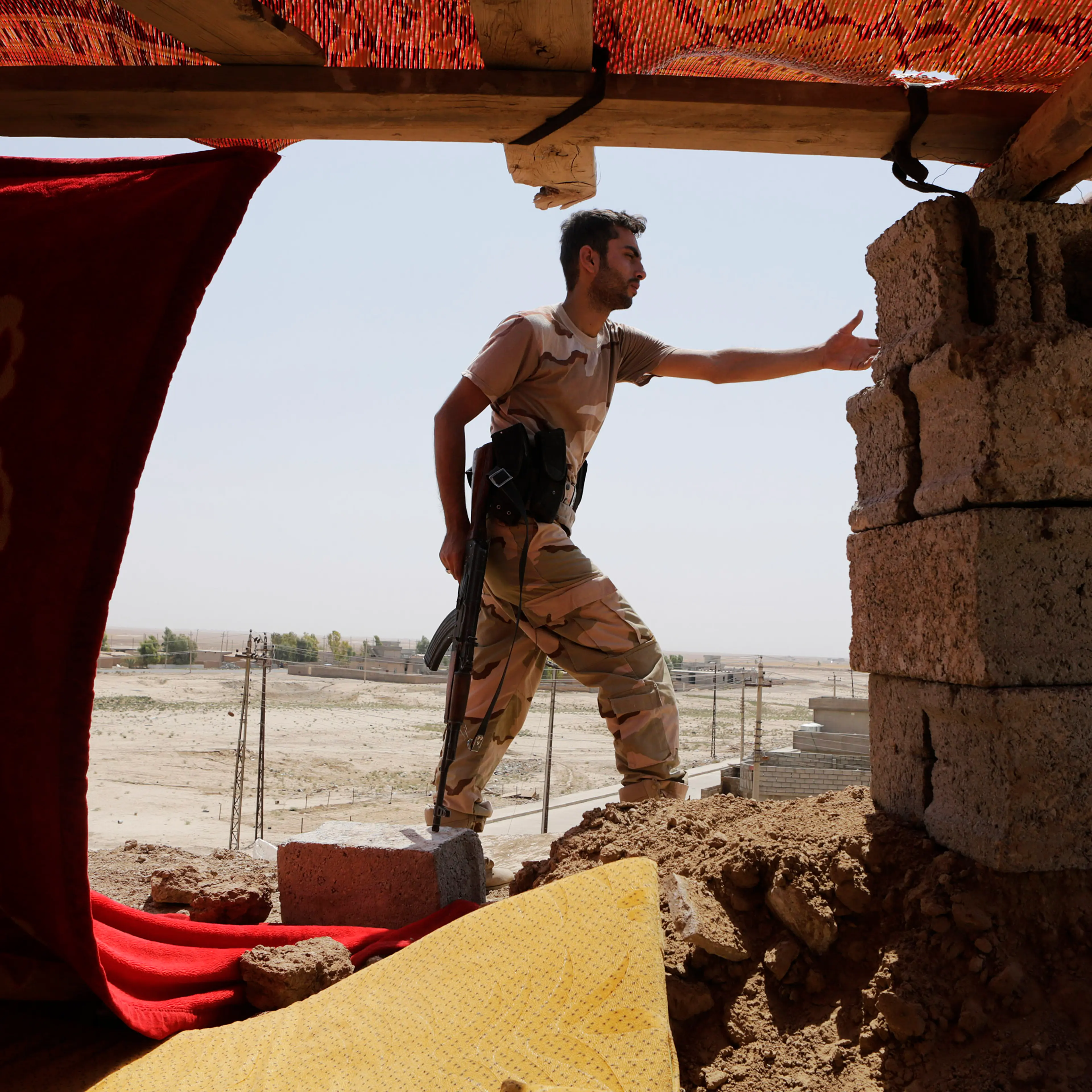 A Kurdish Peshmerga fighter stands guard at the Bakirta frontline near the town of Makhmur, south of Erbil, the capital of Iraqi Kurdistan on Aug. 27, 2014.