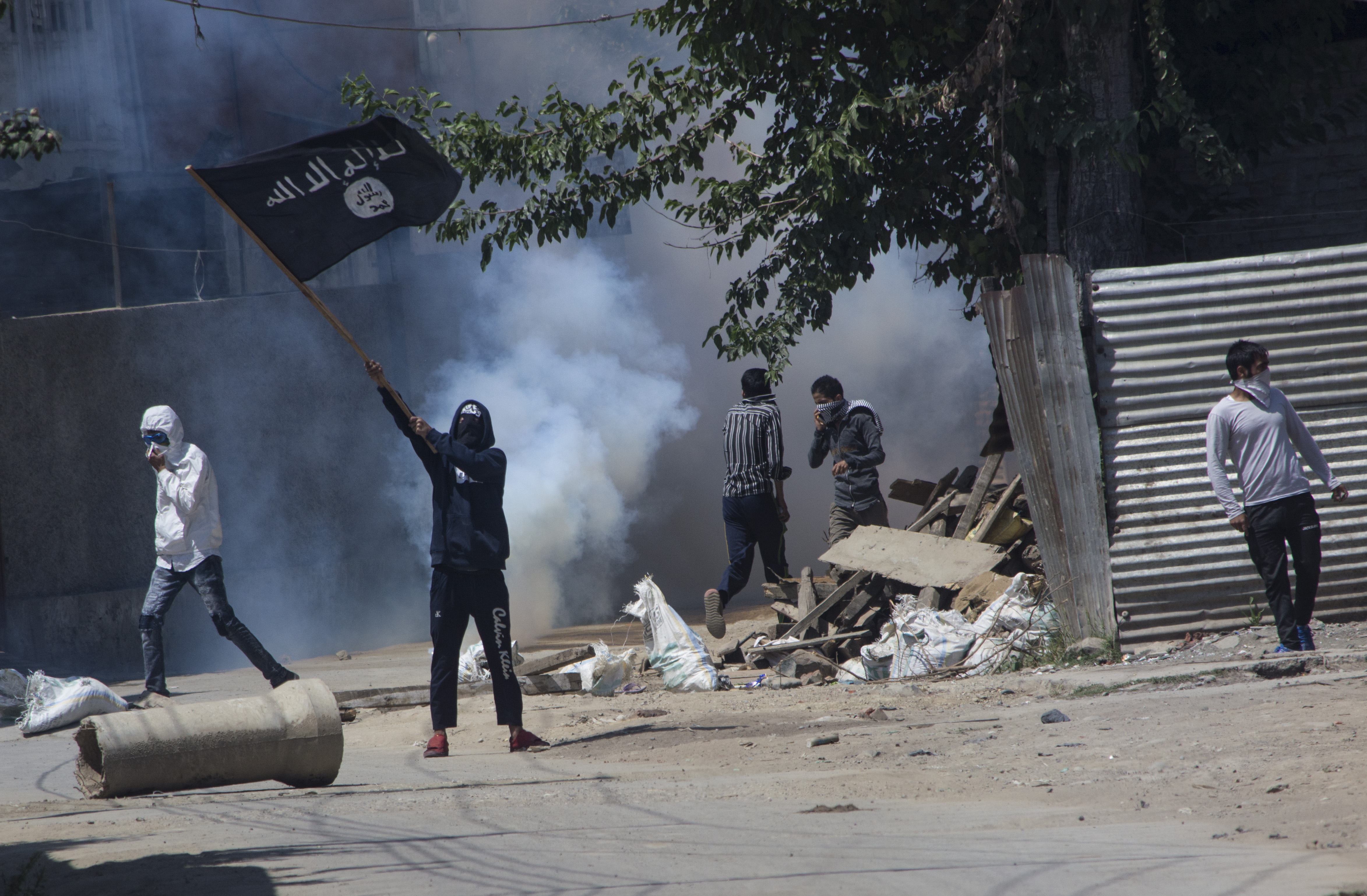 Kashmiri Muslim protestor waves ISIS flag during a funeral