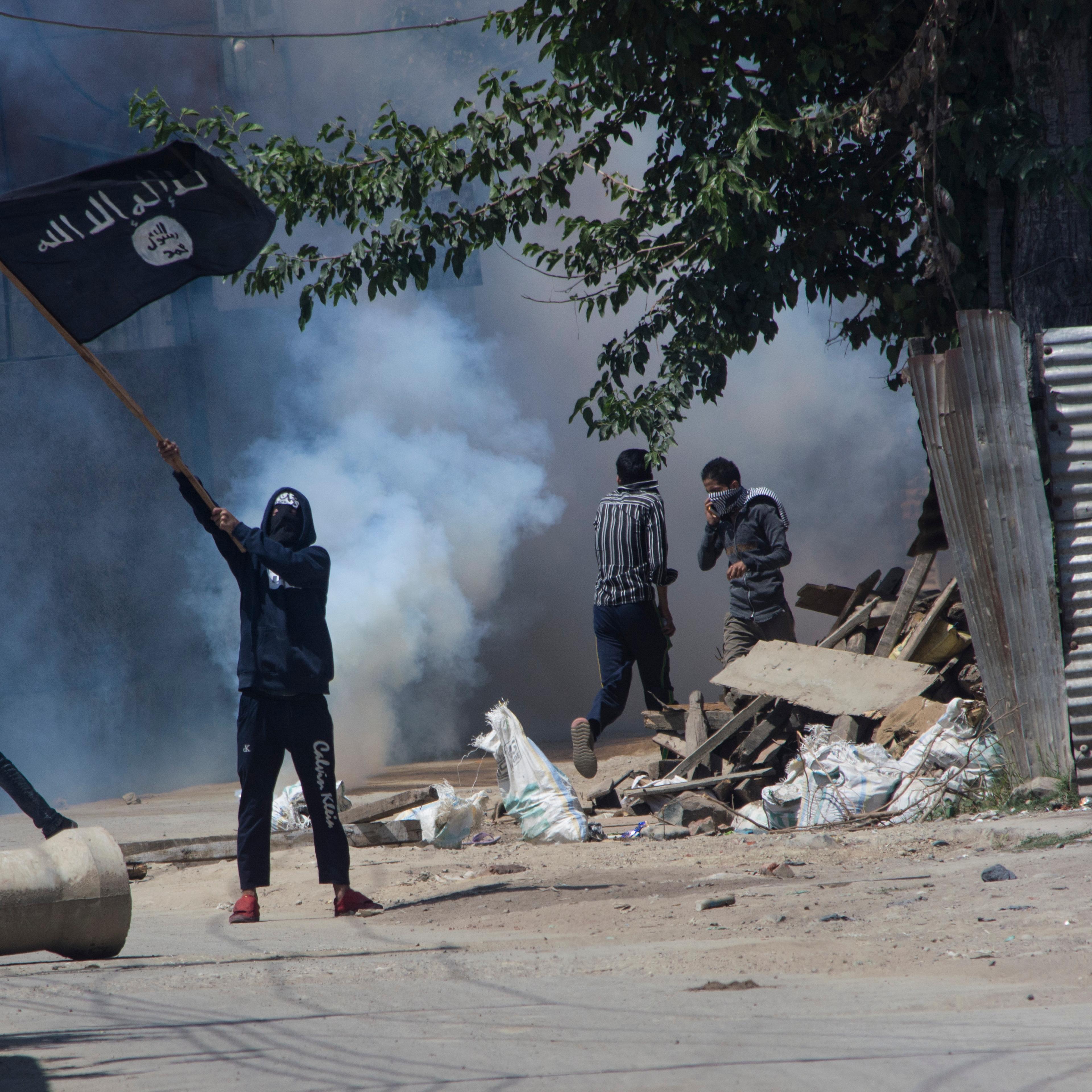 Kashmiri Muslim protestor waves ISIS flag during a funeral