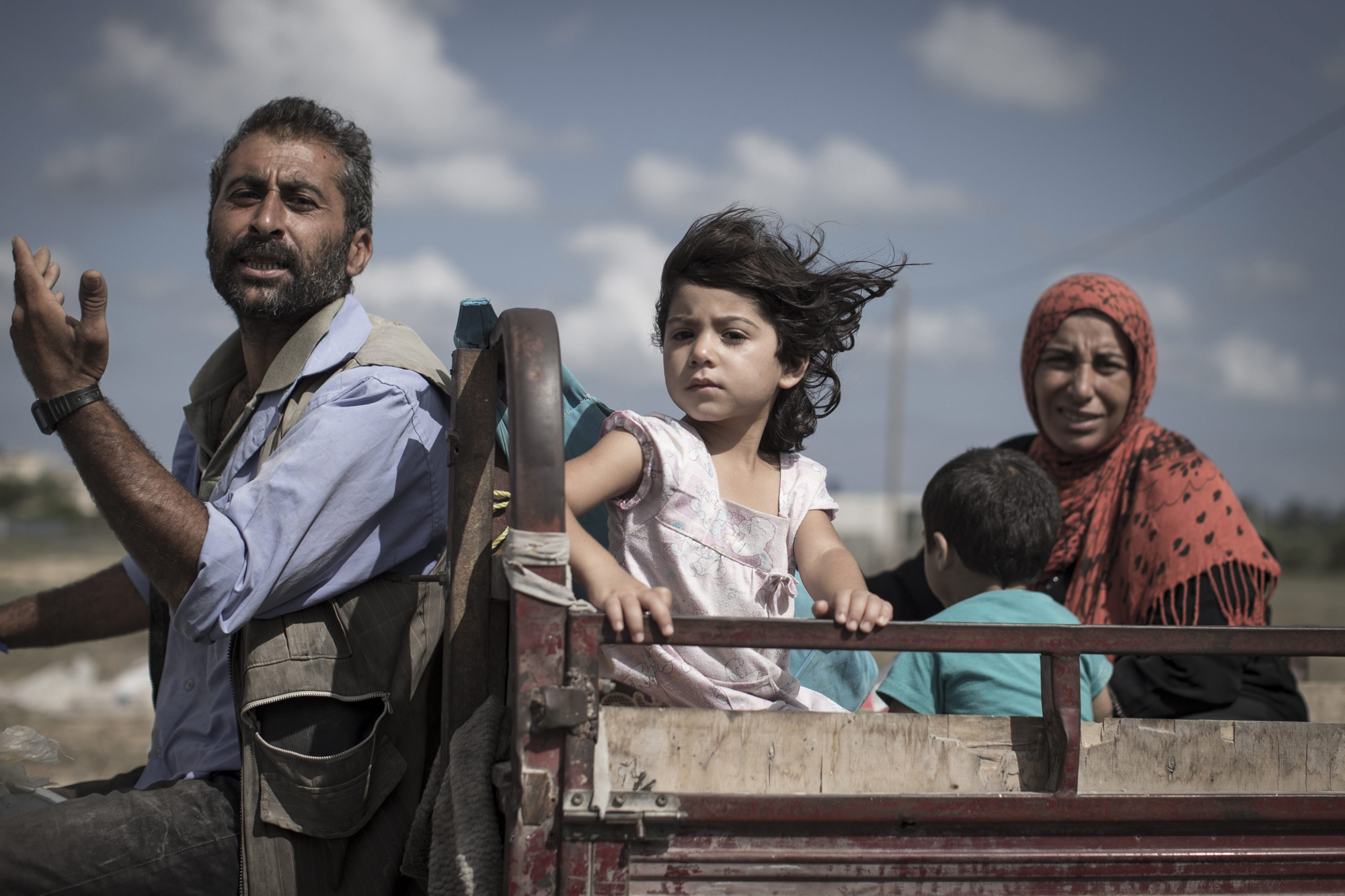 A Palestinian family who fled their homes is en route to seek shelter in a UN school in Khan Younis, central Gaza Strip, 18 July 18, 2014.