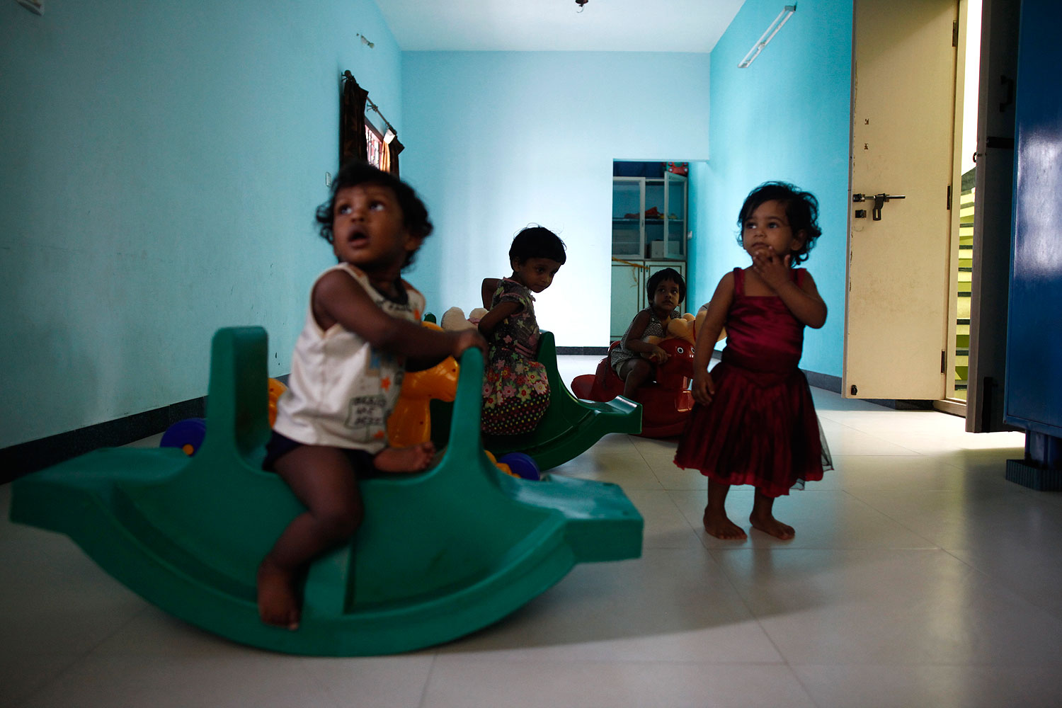 Baby girls play inside the Life Line Trust orphanage in Salem in the southern Indian state of Tamil Nadu June 20, 2013