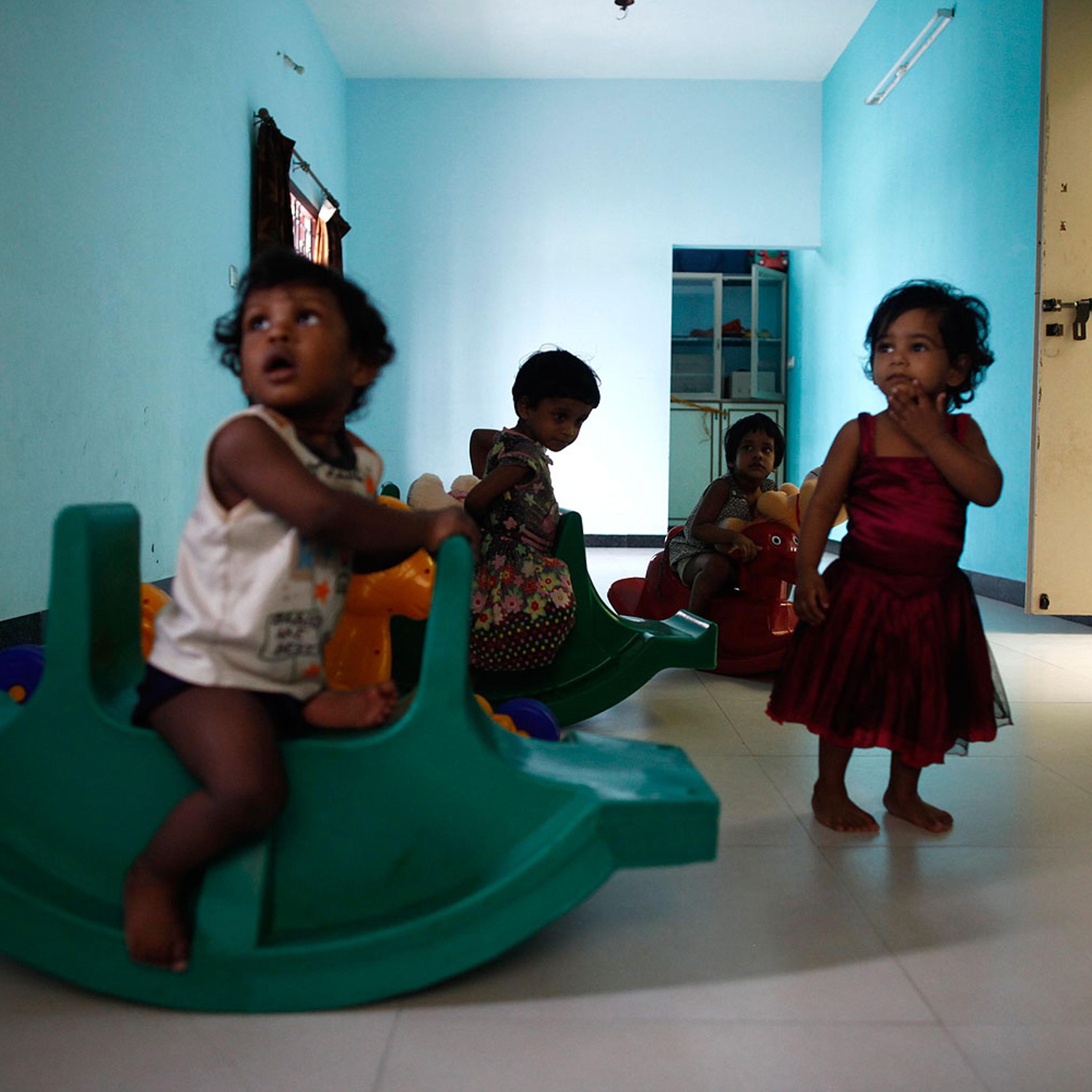 Baby girls play inside the Life Line Trust orphanage in Salem in the southern Indian state of Tamil Nadu June 20, 2013