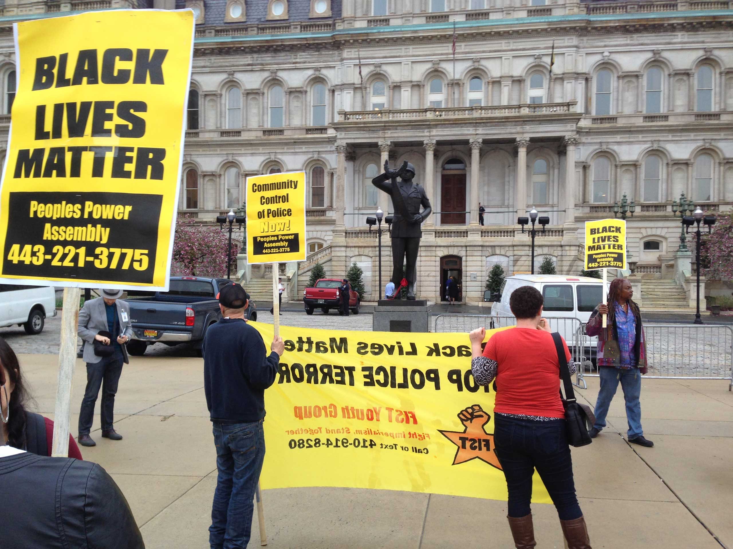 Demonstrators protest the death of Freddie Gray outside Baltimore City Hall on April 20, 2015.