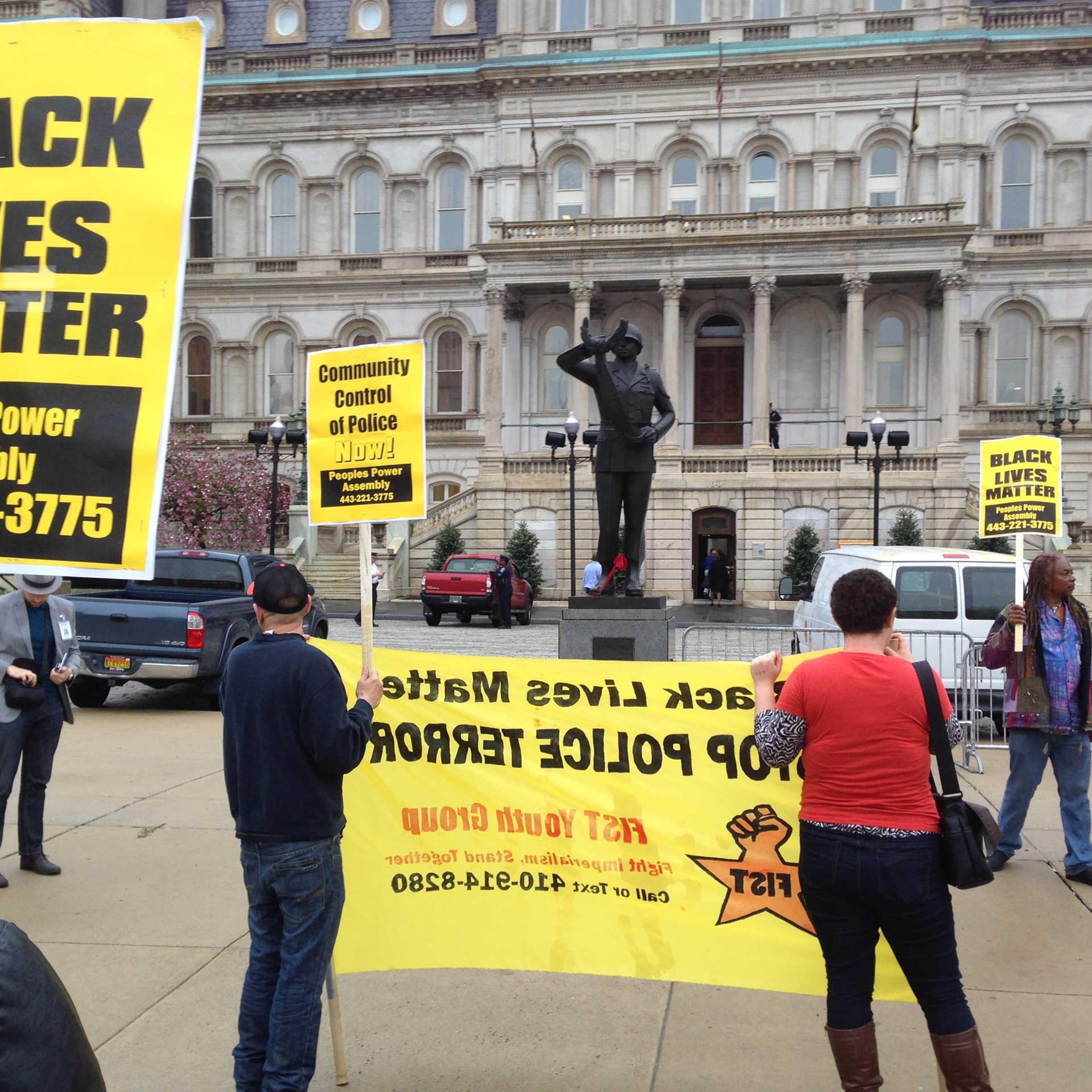Demonstrators protest the death of Freddie Gray outside Baltimore City Hall on April 20, 2015.