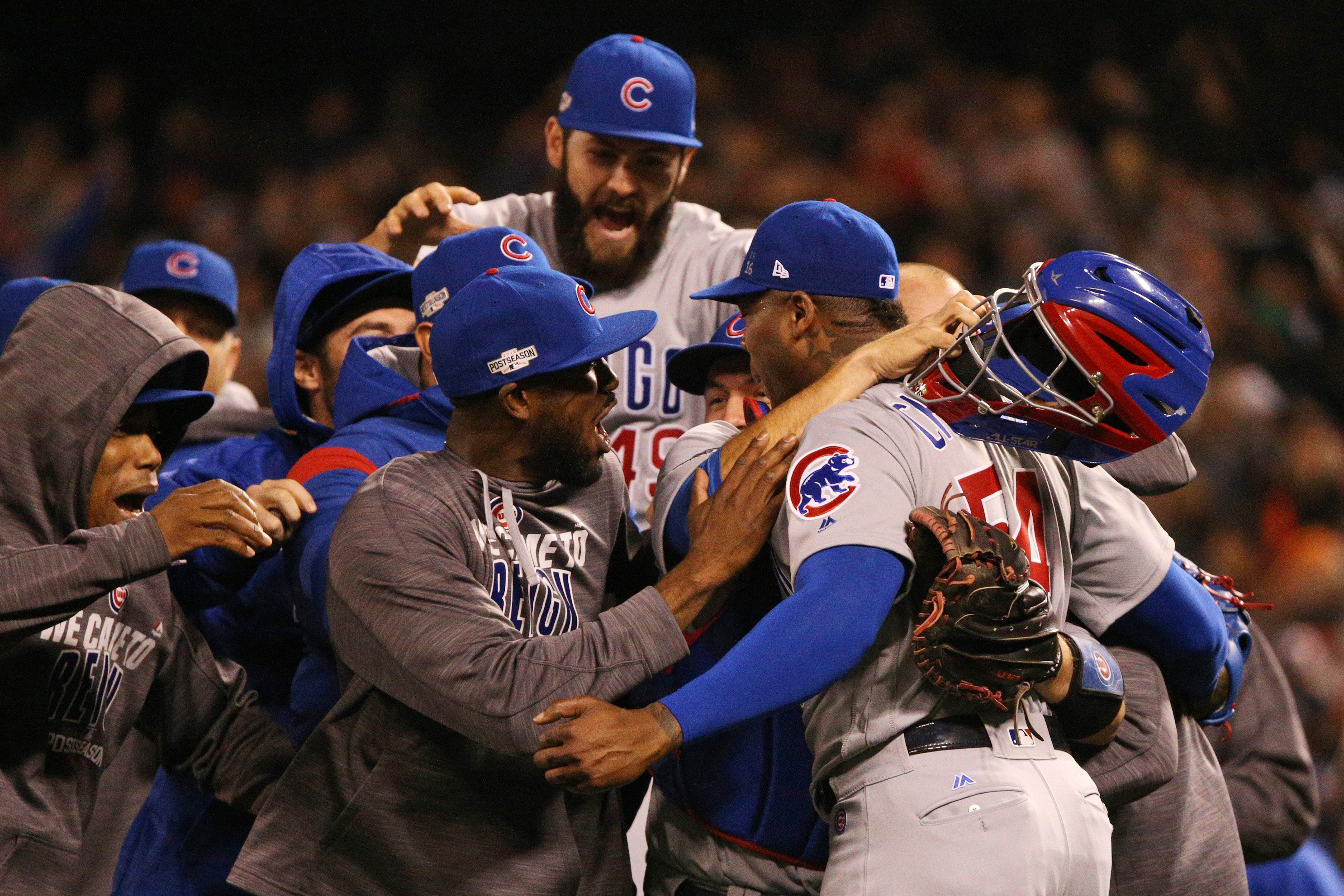 The Chicago Cubs celebrate a 6-5 series-clinching win against the San Francisco Giants in Game 4 of the National League Division Series in San Francisco, on Tuesday, Oct. 11, 2016.