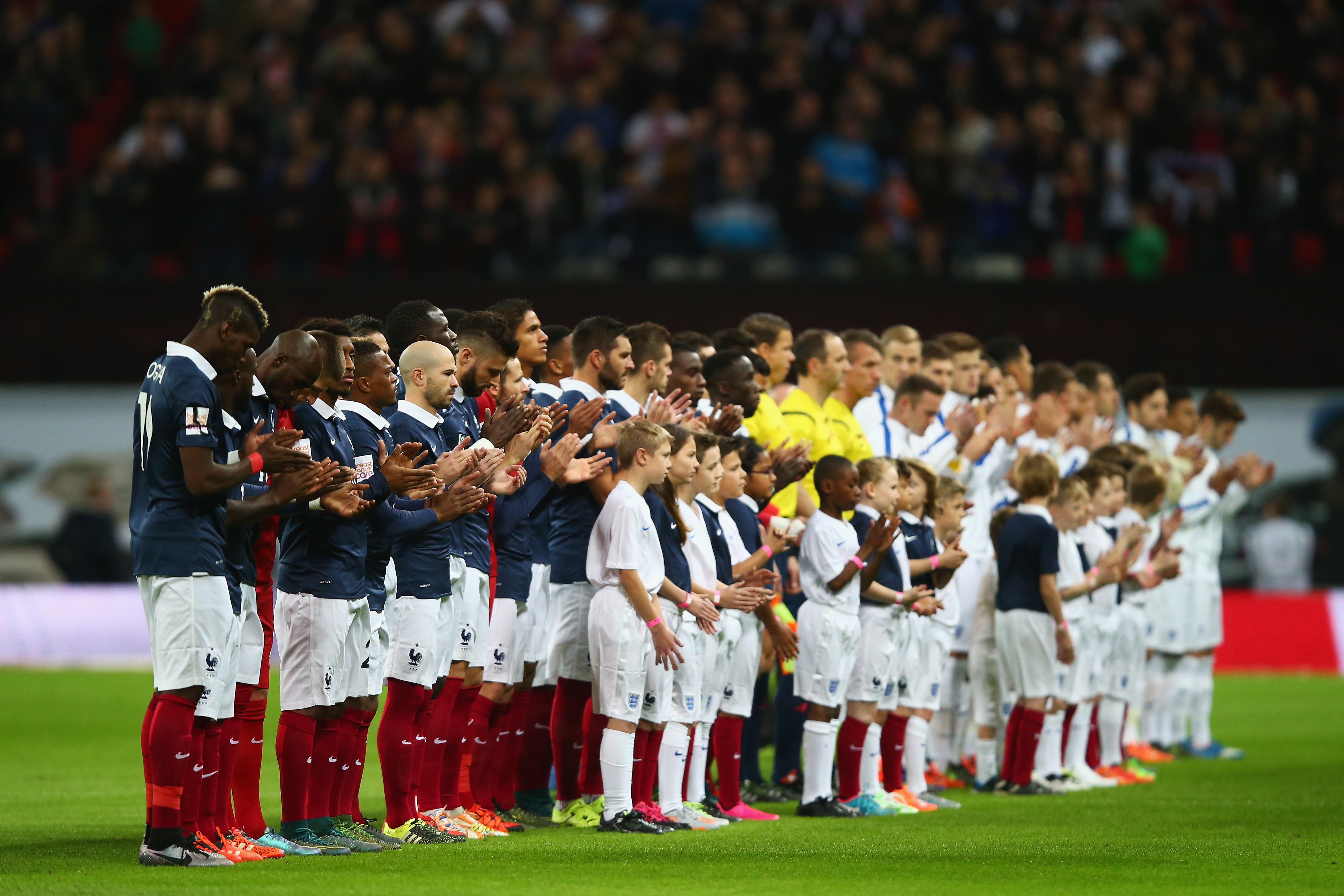 Players line up for the national anthems prior to the International Friendly match between England and France at Wembley Stadium on Nov. 17, 2015 in London.