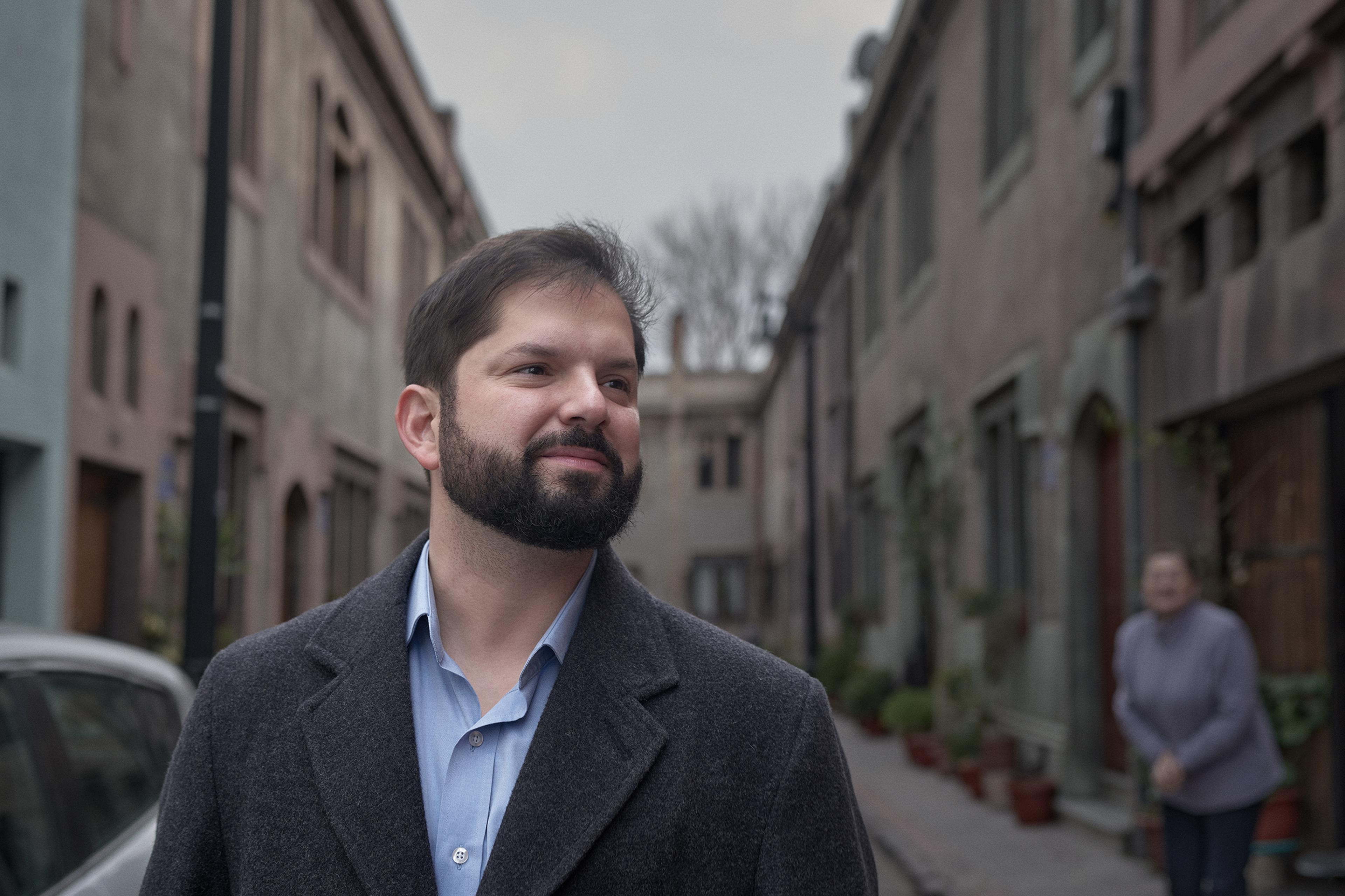 President Gabriel Boric walks down a street in the Yungay neighborhood, Aug. 12. Boric settled in this historic and low income neighborhood of the city of Santiago after assuming the presidency.