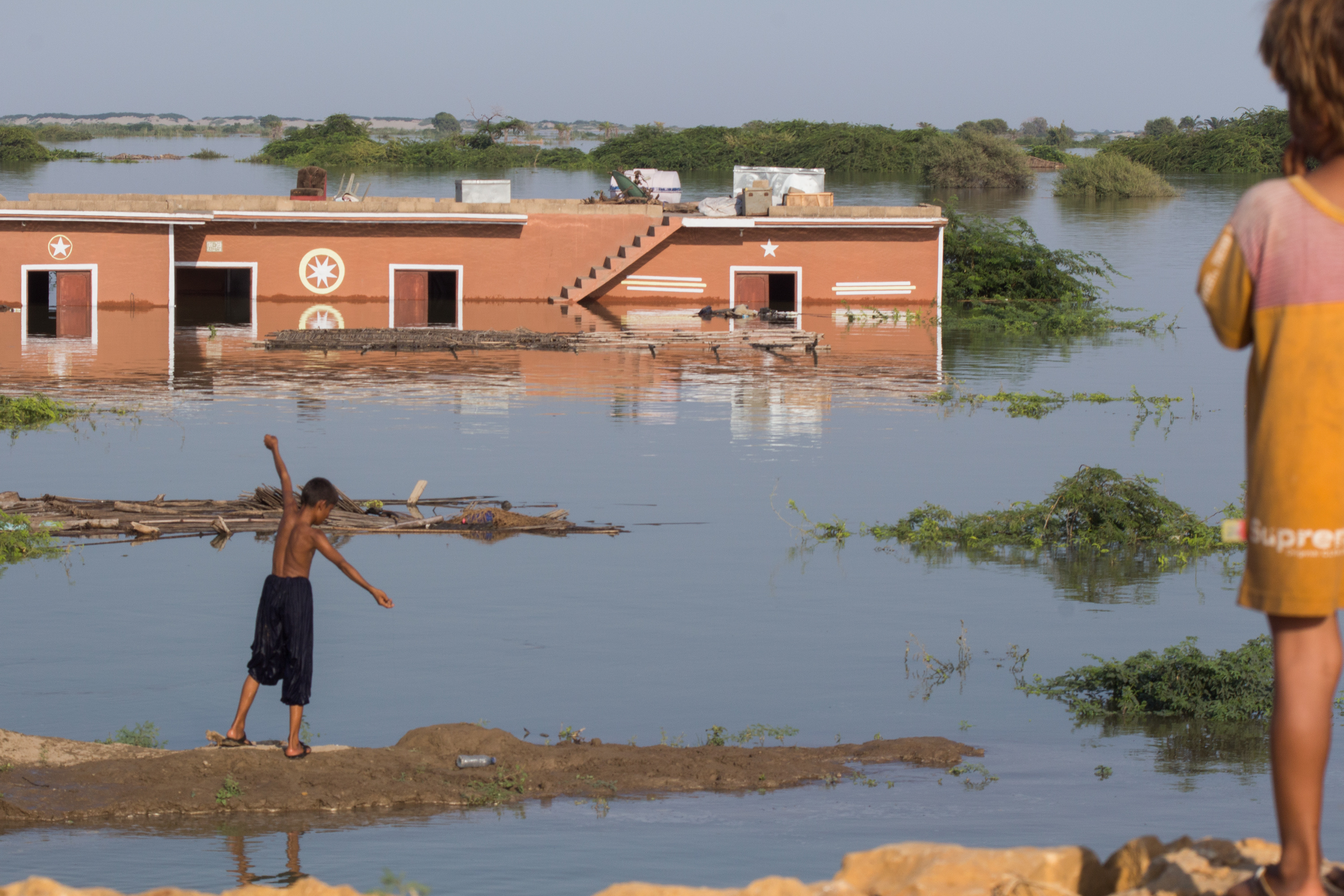 Children play in front of a submerged house on the outskirts of Faqir Jo Goth, Sindh province, Pakistan, Sept. 8.