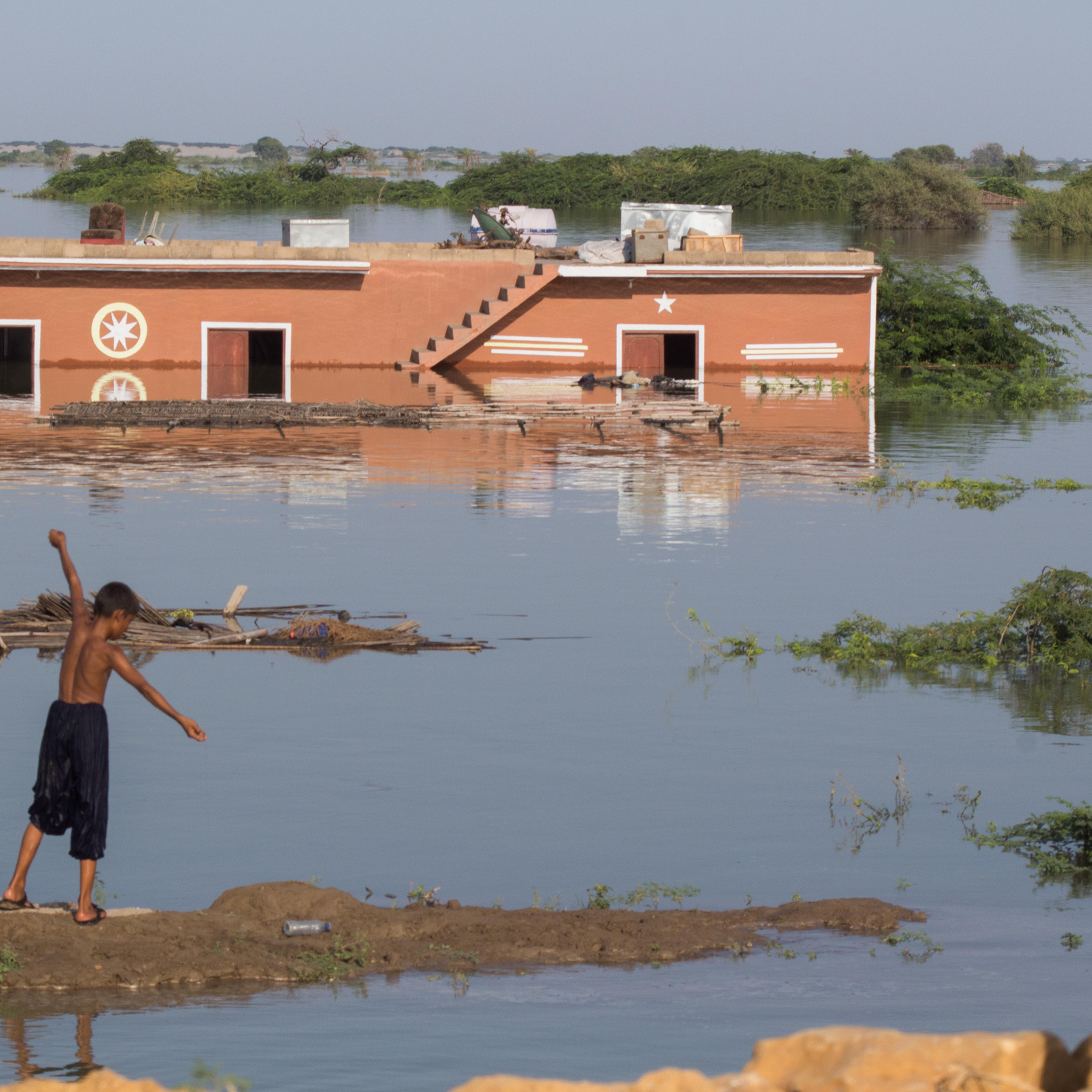 Children play in front of a submerged house on the outskirts of Faqir Jo Goth, Sindh province, Pakistan, Sept. 8.