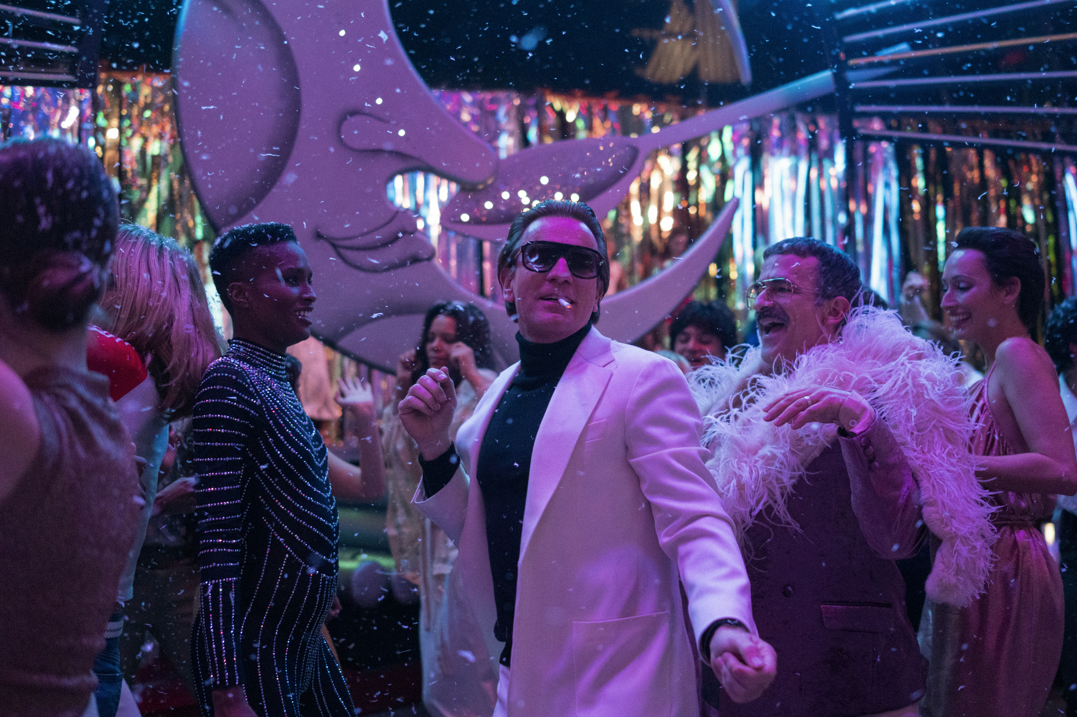 HALSTON (L to R) EWAN MCGREGOR as HALSTON, DAVID PITTU as JOE EULA, and REBECCA DAYAN as ELSA PERETTI in episode 104 of HALSTON Cr. ATSUSHI NISHIJIMA/NETFLIX © 2021