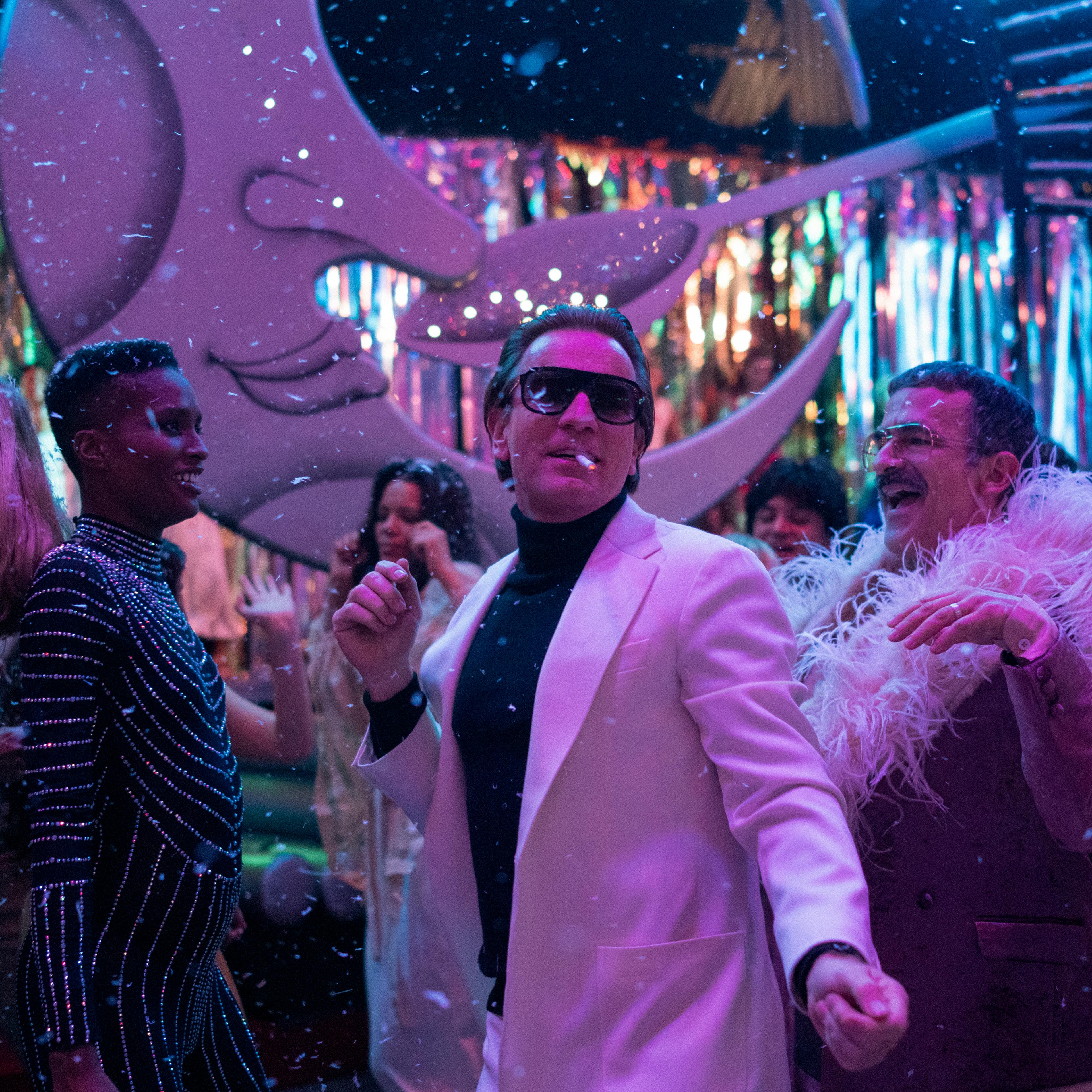 HALSTON (L to R) EWAN MCGREGOR as HALSTON, DAVID PITTU as JOE EULA, and REBECCA DAYAN as ELSA PERETTI in episode 104 of HALSTON Cr. ATSUSHI NISHIJIMA/NETFLIX © 2021