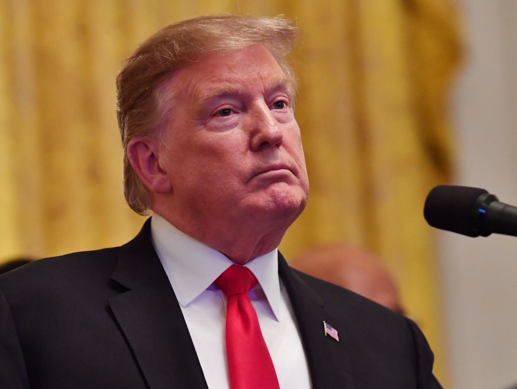 US President Donald Trump listens during a White House reception in honor of National African American History Month